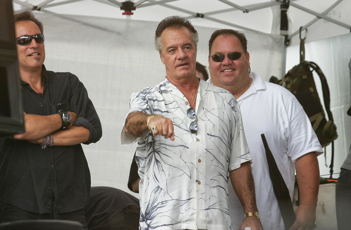 Tony Sirico gestures with his fist on-stage as Bruce Springsteen stands to his right