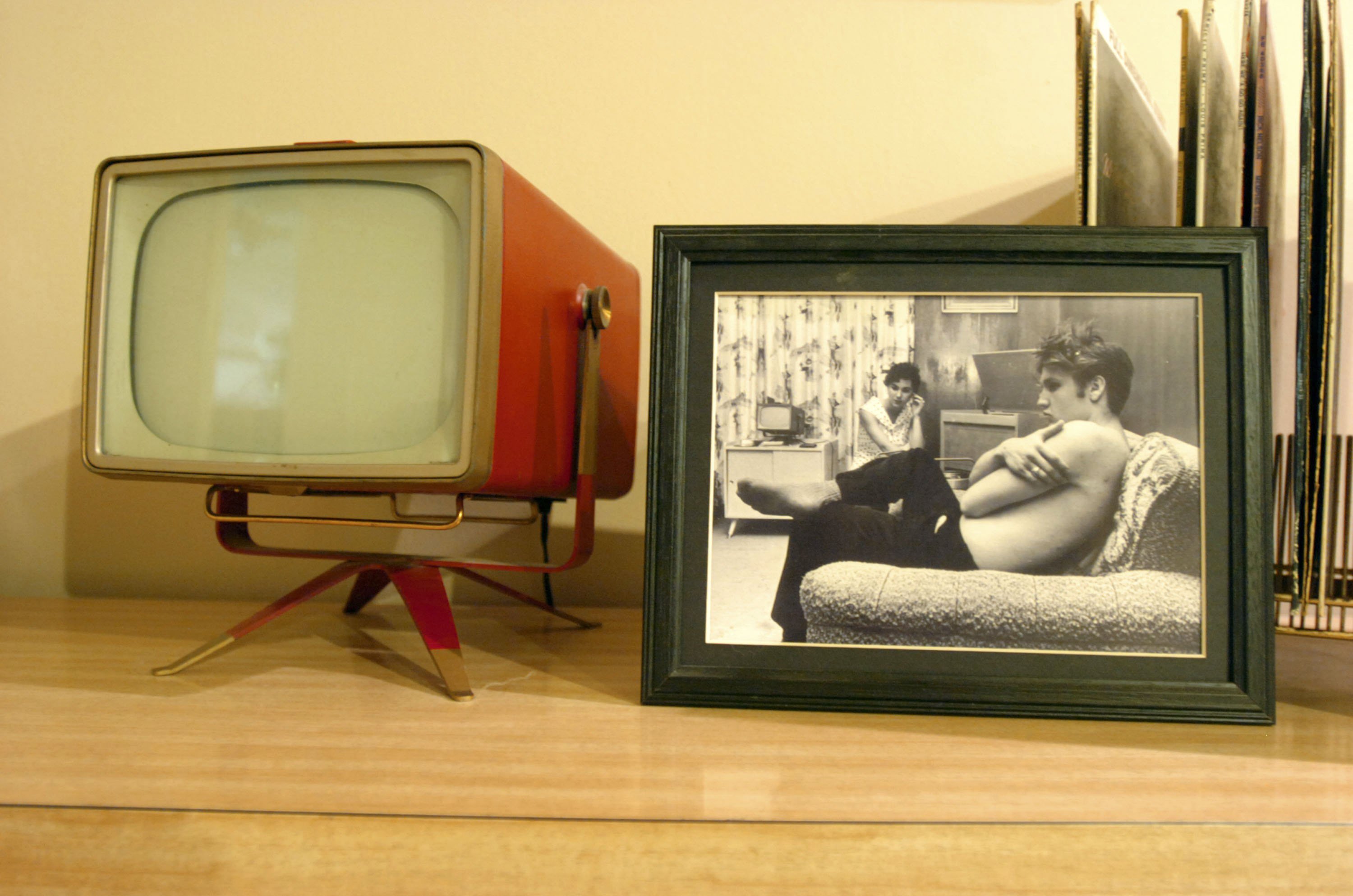A vintage television near a picture of Elvis Presley