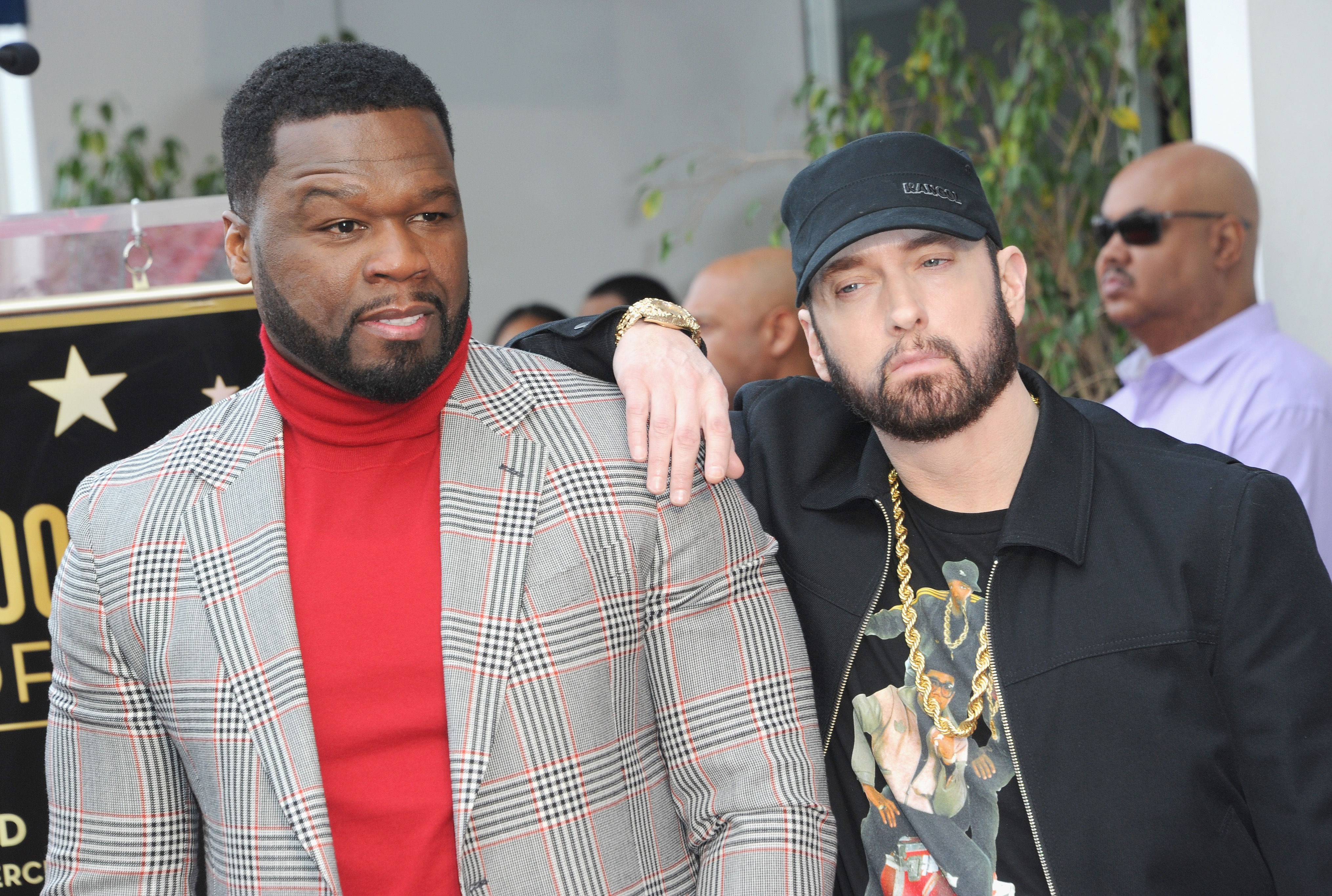 50 Cent and Eminem take a photo together at a ceremony honoring 50 with a star on the Hollywood Walk of Fame