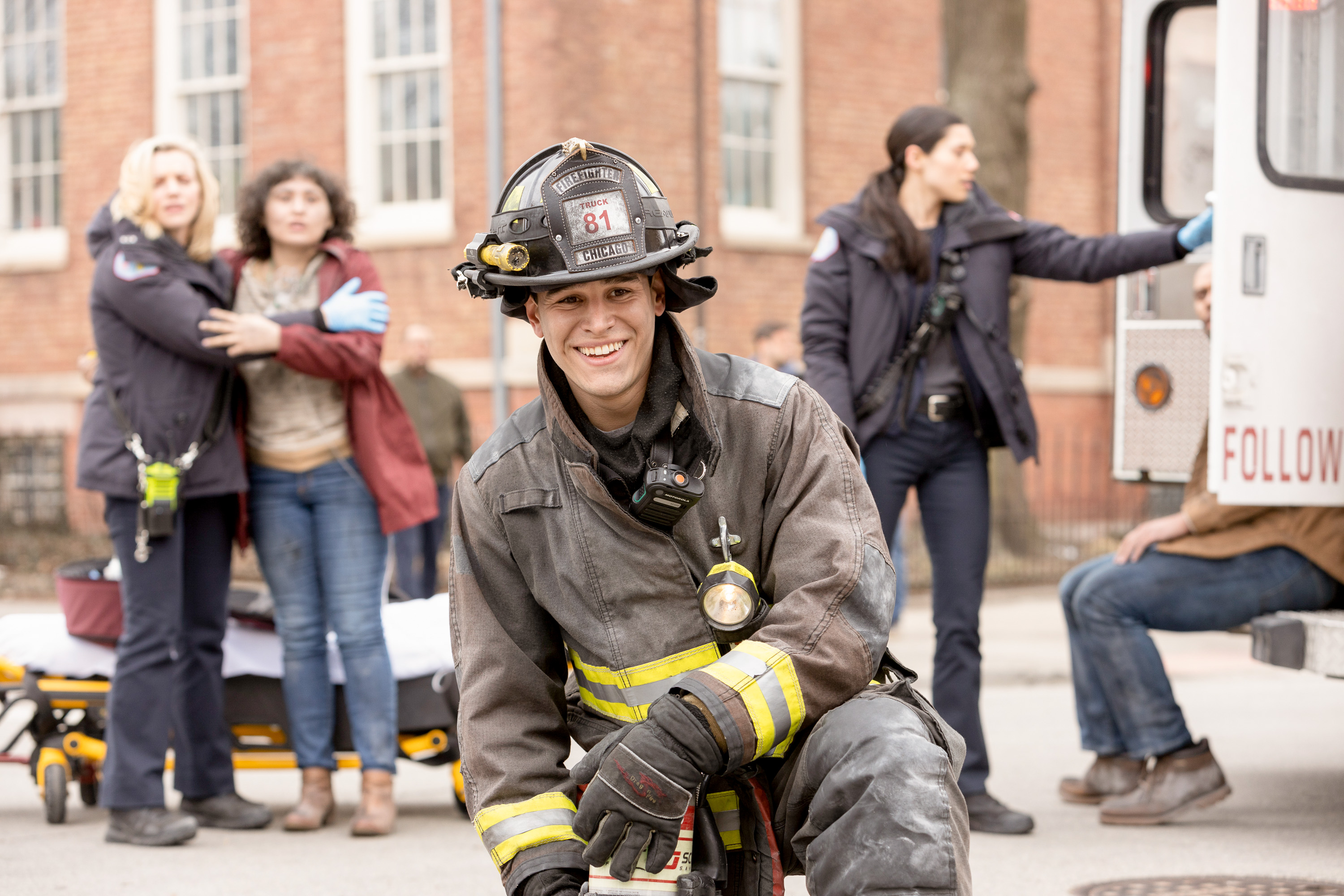 Alberto Rosende as Blake Gallo on 'Chicago Fire' kneels at the scene of an accident.
