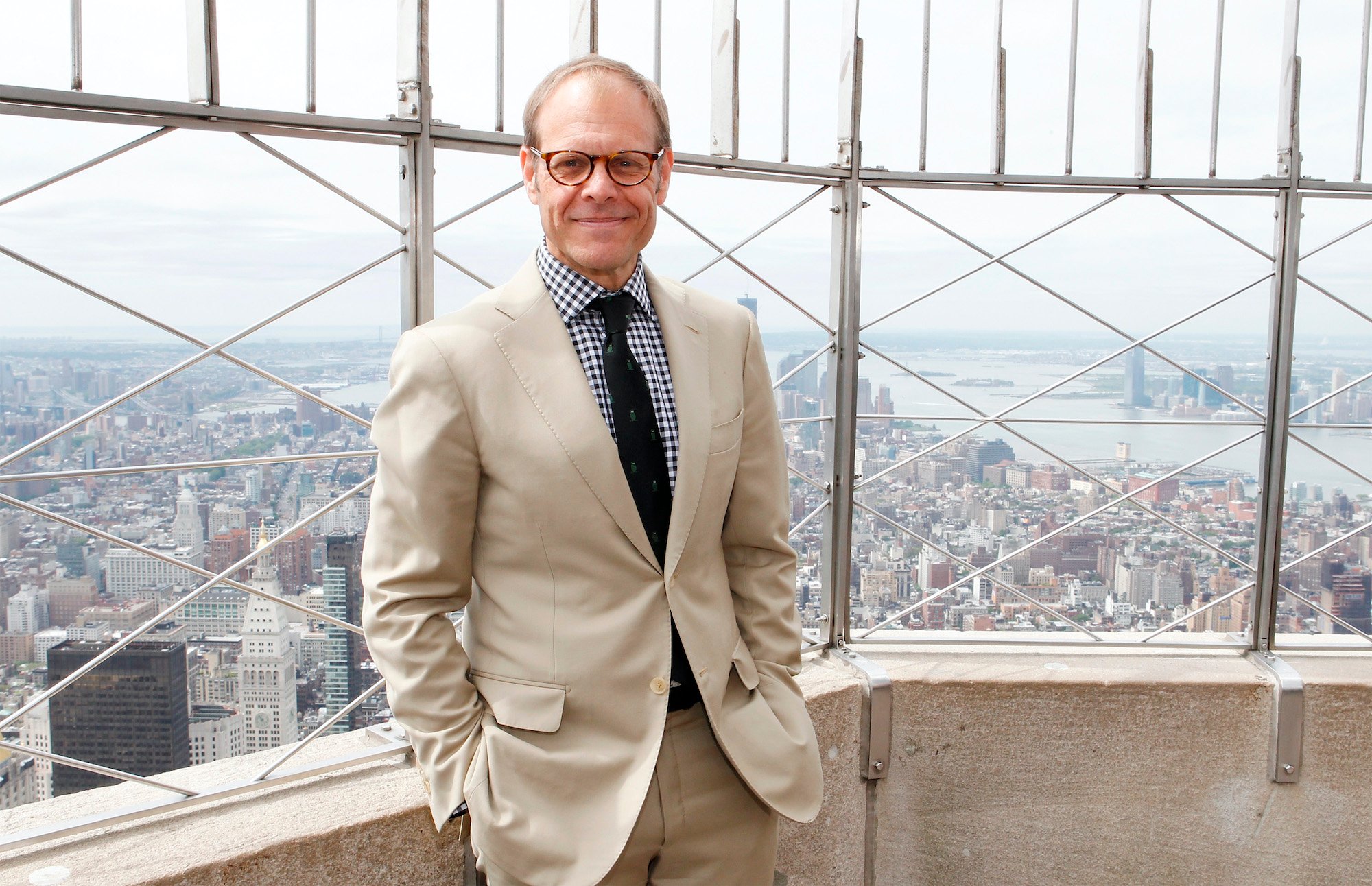 Alton Brown smiling, standing on the Empire State Building