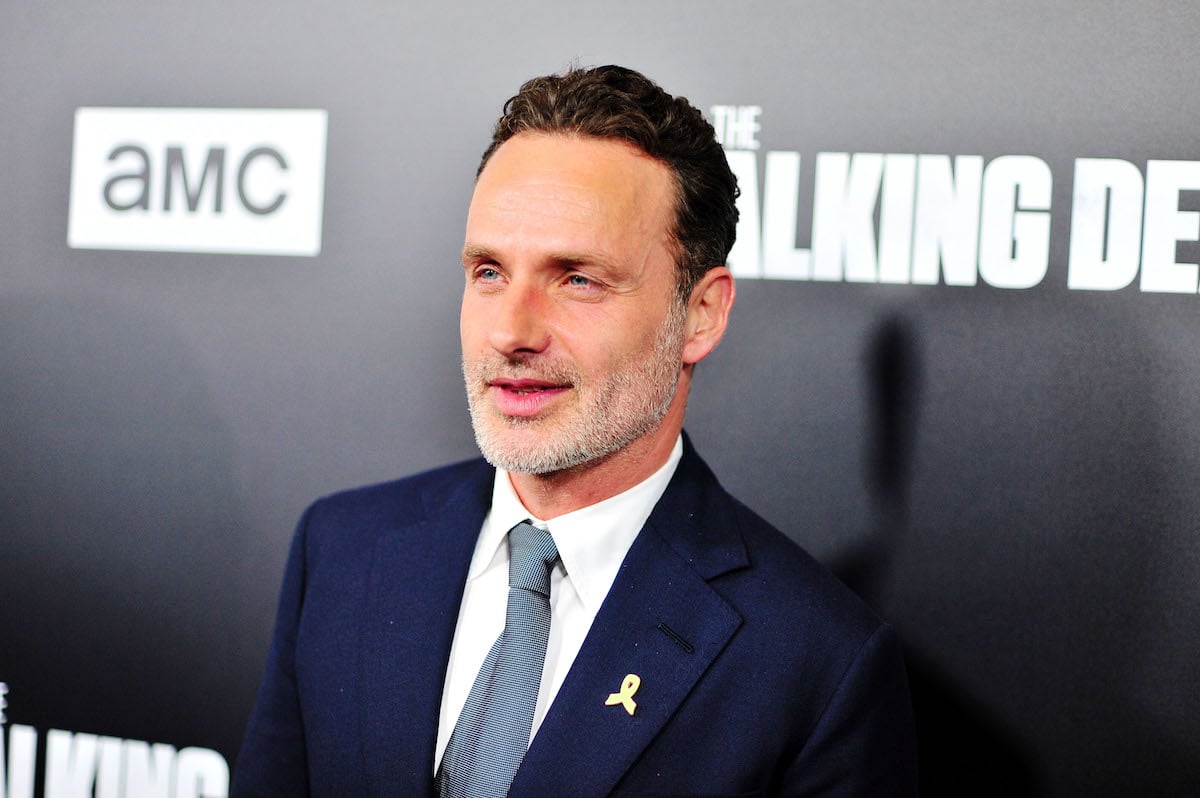 Andrew Lincoln poses in a blue suit and tie on the red carpet.