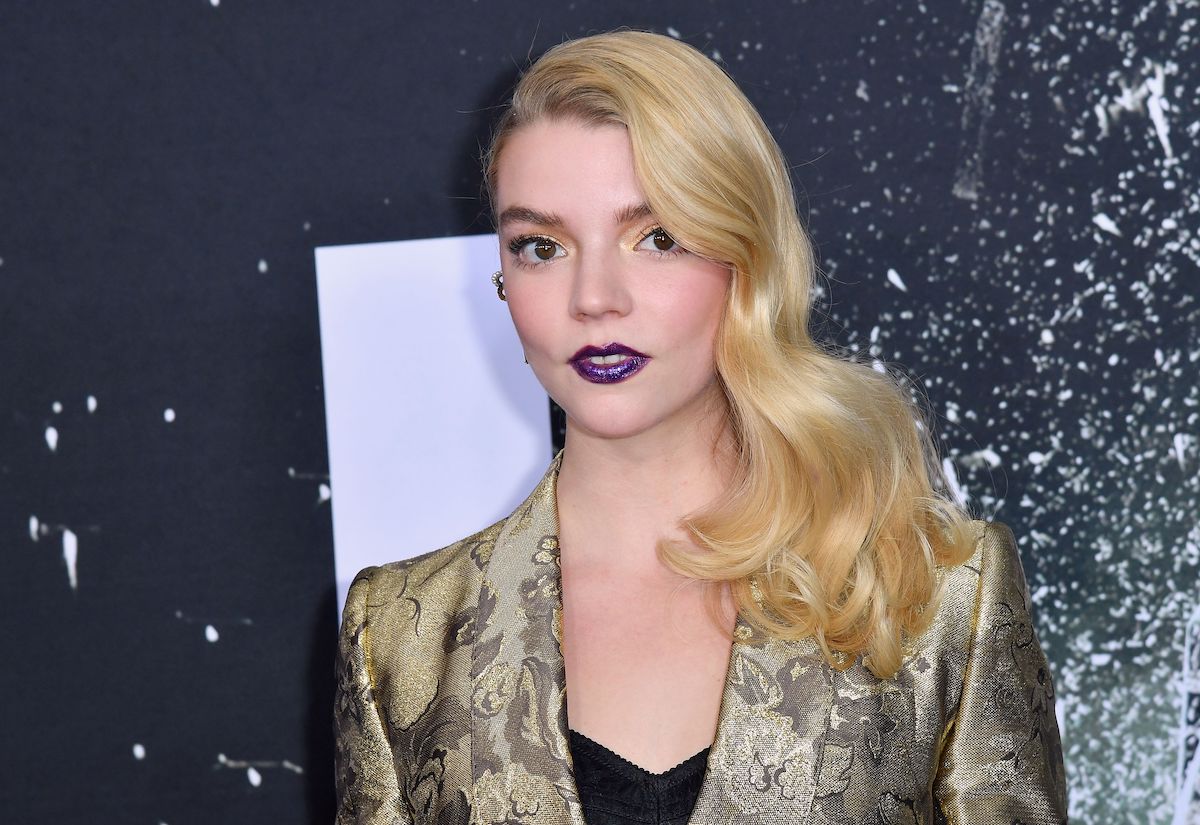 Anya Taylor-Joy poses in a gold jacket at the 'Glass' premiere