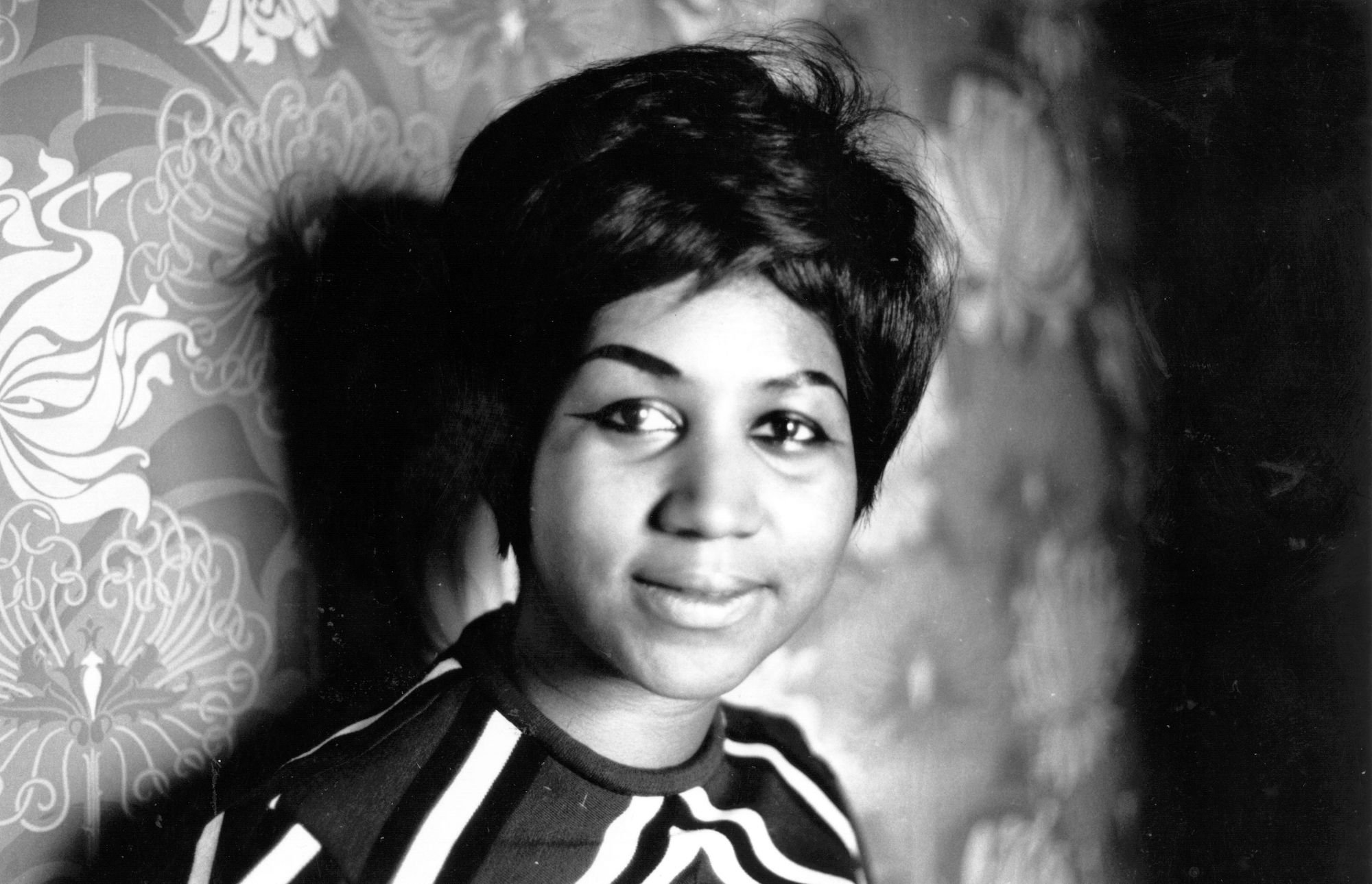 Aretha Franklin smiling, in black and white