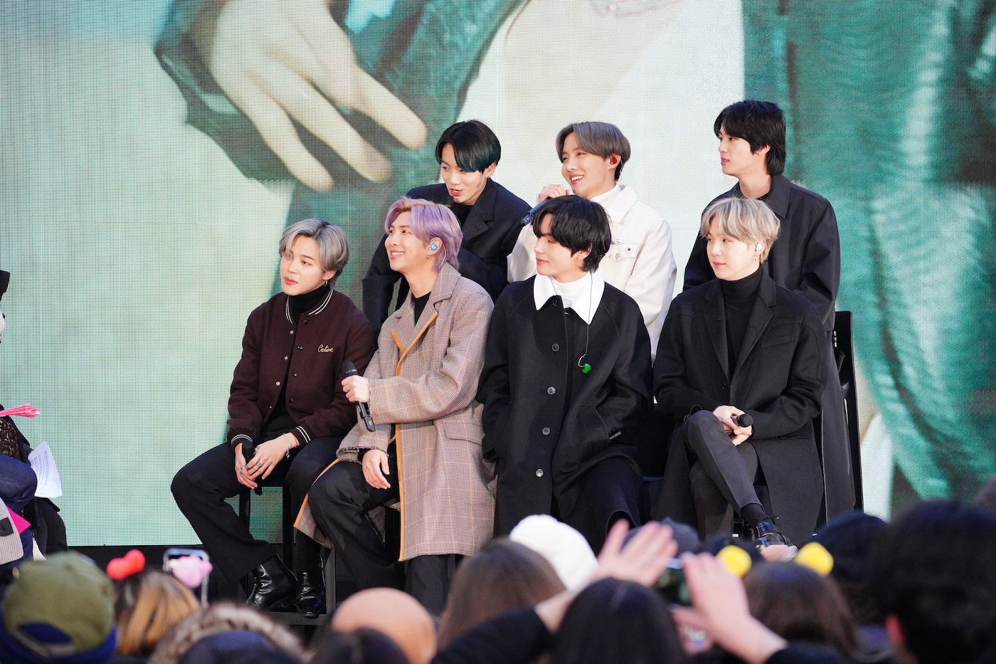 J-Hope, SUGA, Jungkook, Jimin, RM, V and Jin of the K-pop band BTS sitting outside in New York City