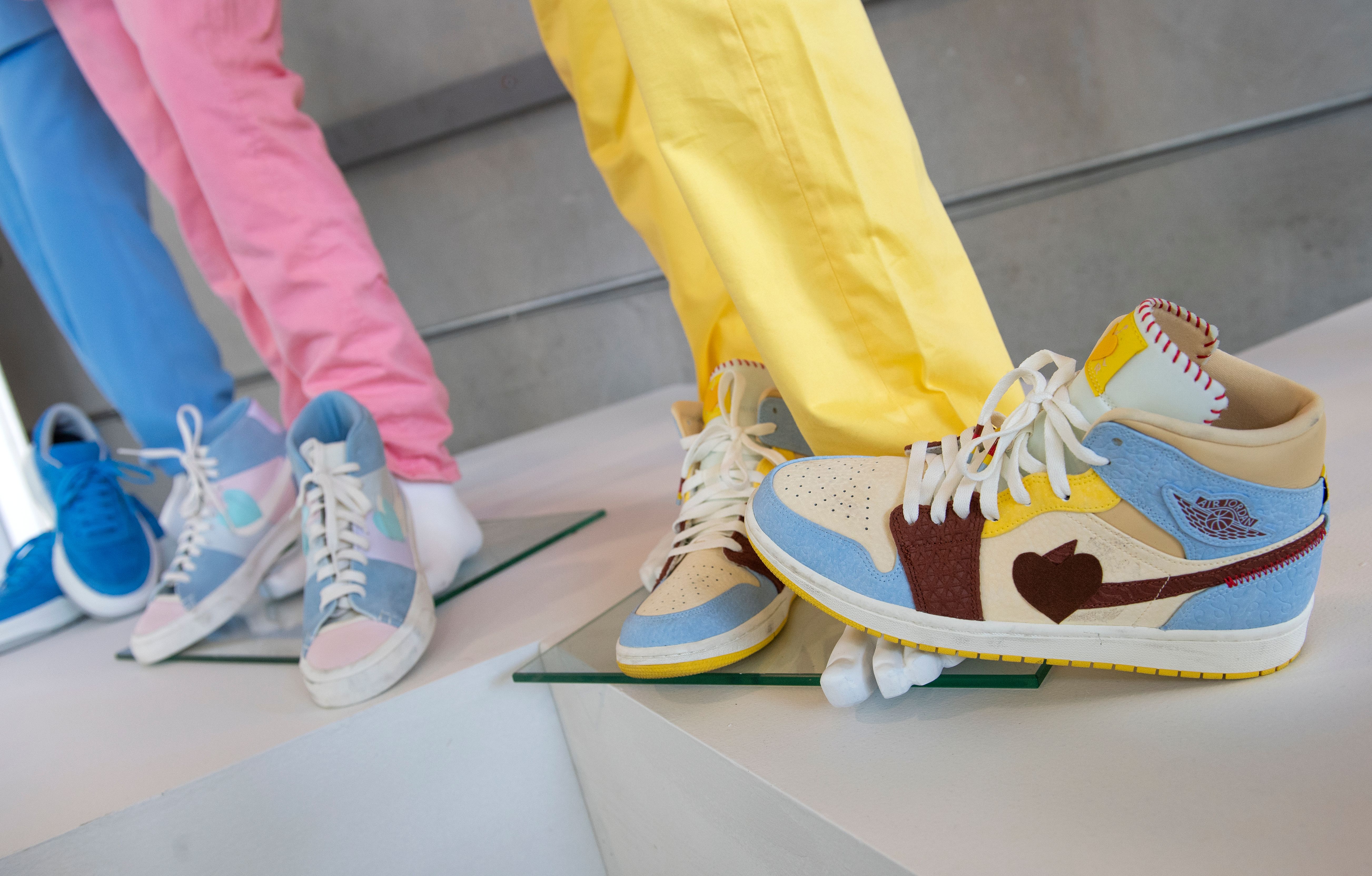 Custom Nike Air Jordan worn by K-pop BTS band member Suga, Custom Nike Air worn by K-pop BTS band member Jin, and Blue converse All-Star worn by K-pop BTS band member V on their "Dynamite" music video