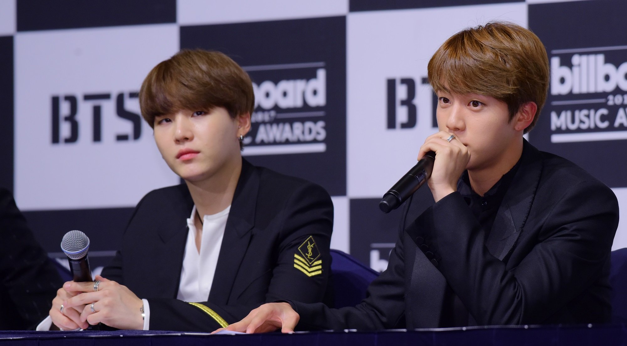 Suga and Jin of BTS at a press conference for the 2017 Billboard Music Awards