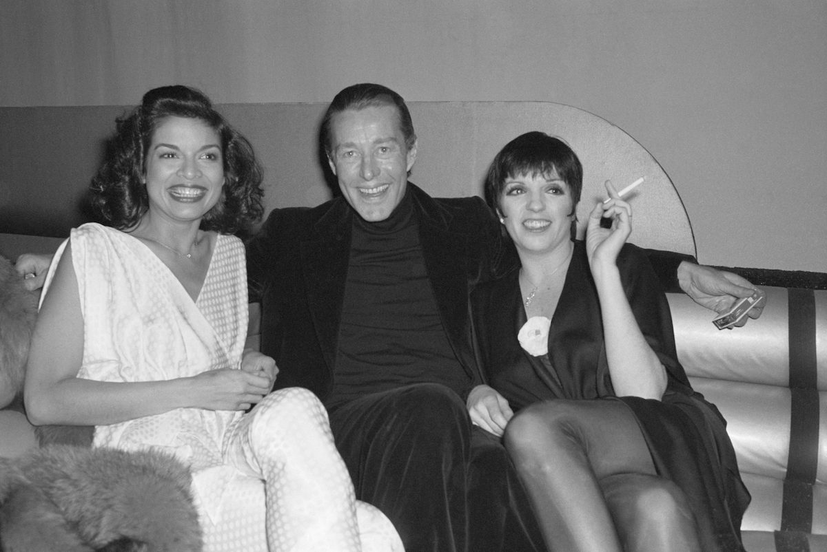 black and white photo of Bianca Jagger, Halston, and Liza Minnelli sitting on a couch