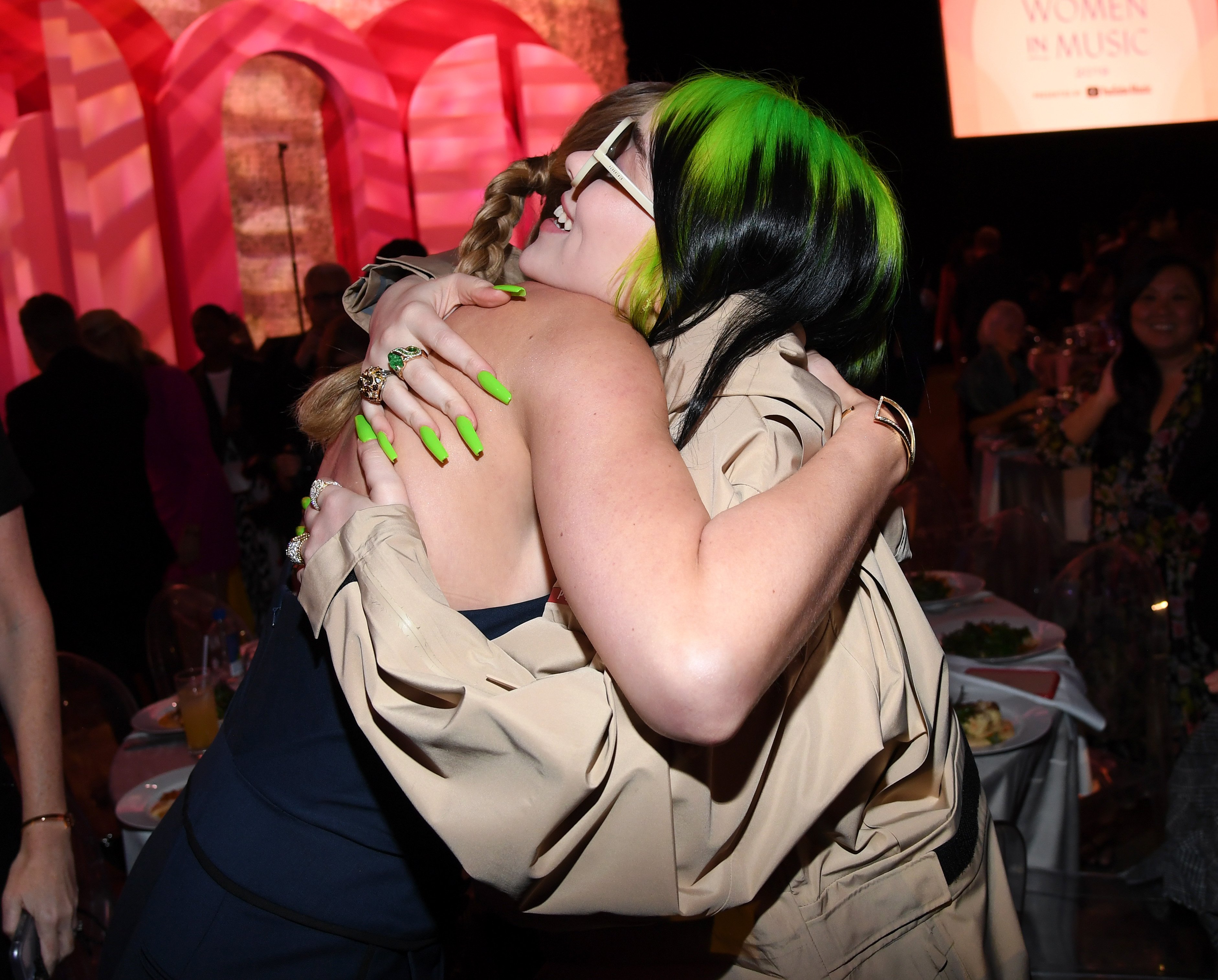 Taylor Swift and Billie Eilish attend Billboard Women In Music 2019, hugging in the picture