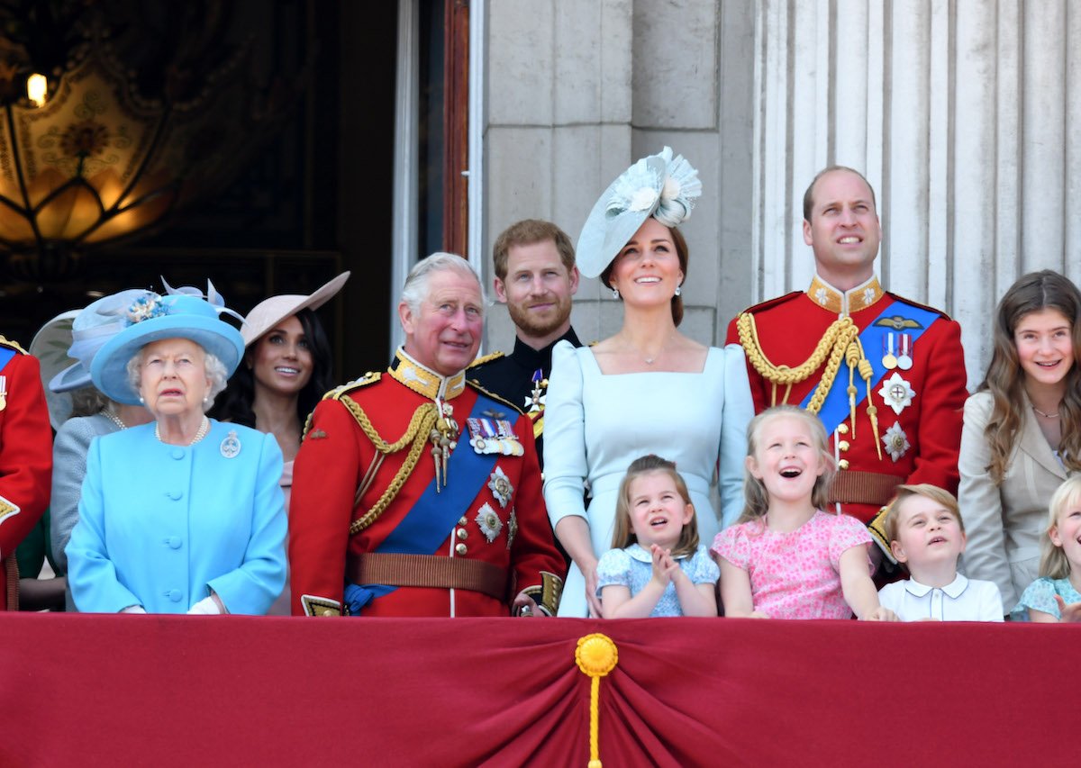 (L-R): Queen Elizabeth II, Prince Charles, Meghan Markle, Prince Harry, Kate Middleton, Prince William, Princess Charlotte, Savannah Phillips, and Prince George stand on the balcony of Buckingham Palace during the 2018 Trooping the Colour