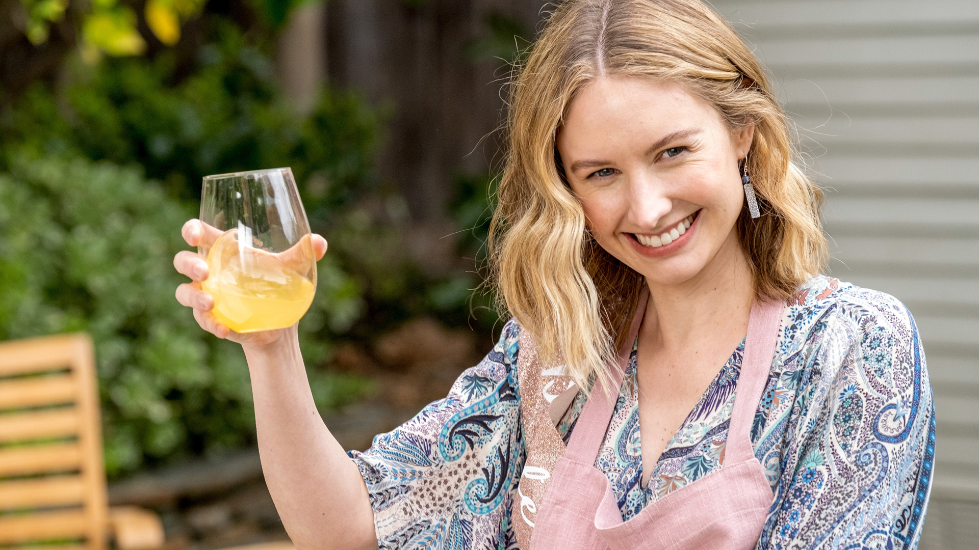 Caitlin Thompson lifts a glass of lemonade as Madison in ‘This Is Us’ Season 5 Episode 15, ‘Jerry 2.0’