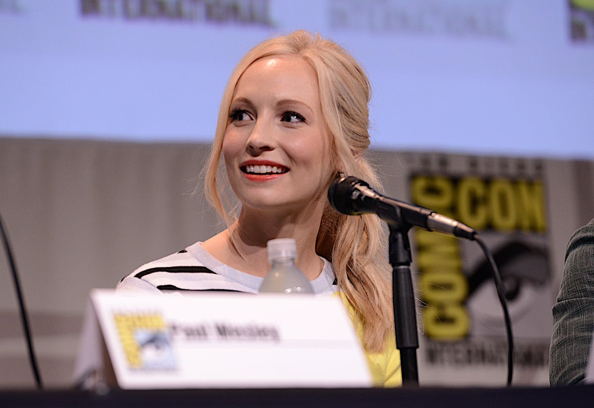 Candice King in a black and white striped shirt speaking at 'The Vampire Diaries' panel at Comic Con 2015