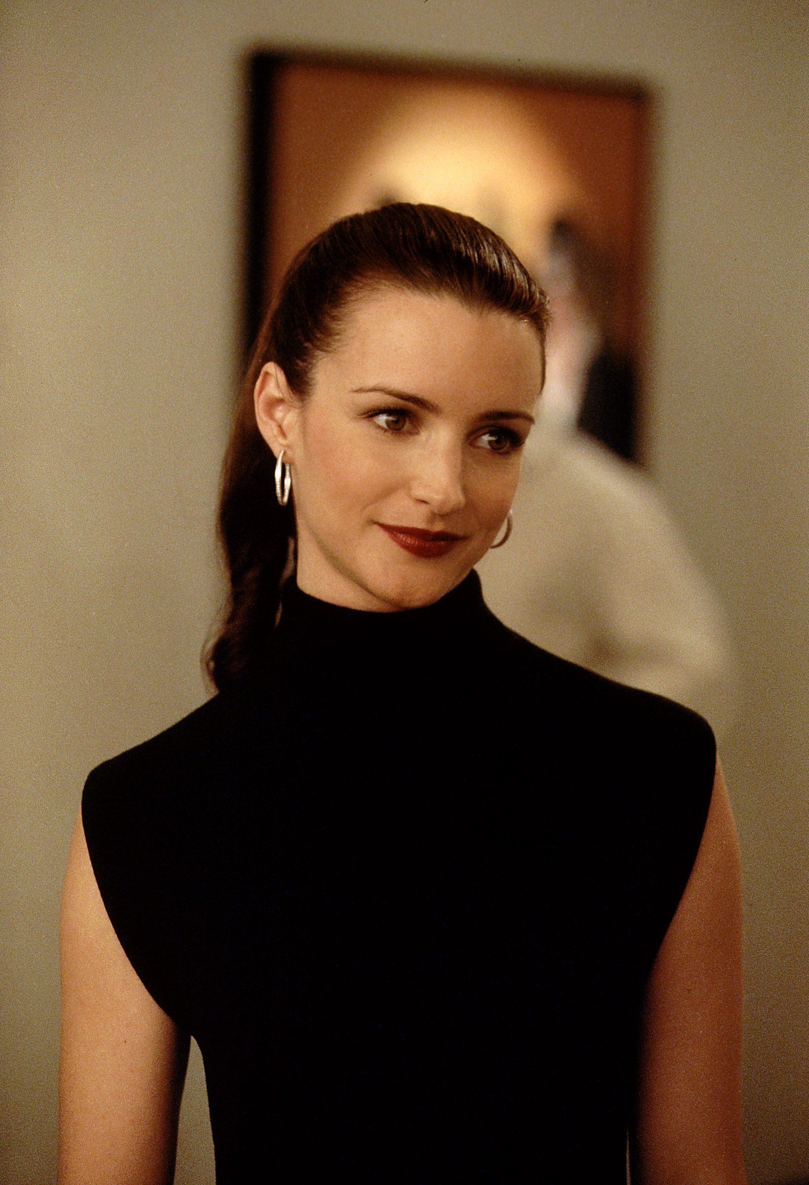 Kristin Davis as Charlotte York stands in the art gallary where she works in season 3 of 'Sex and the City'