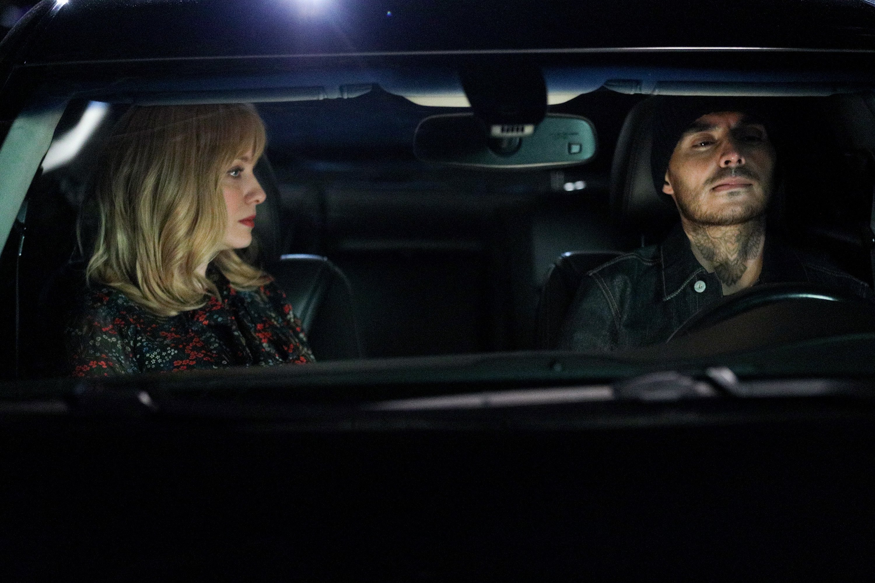 'Good Girls': Christina Hendricks as Beth Boland glaring at Manny Montana as Rio in a car.