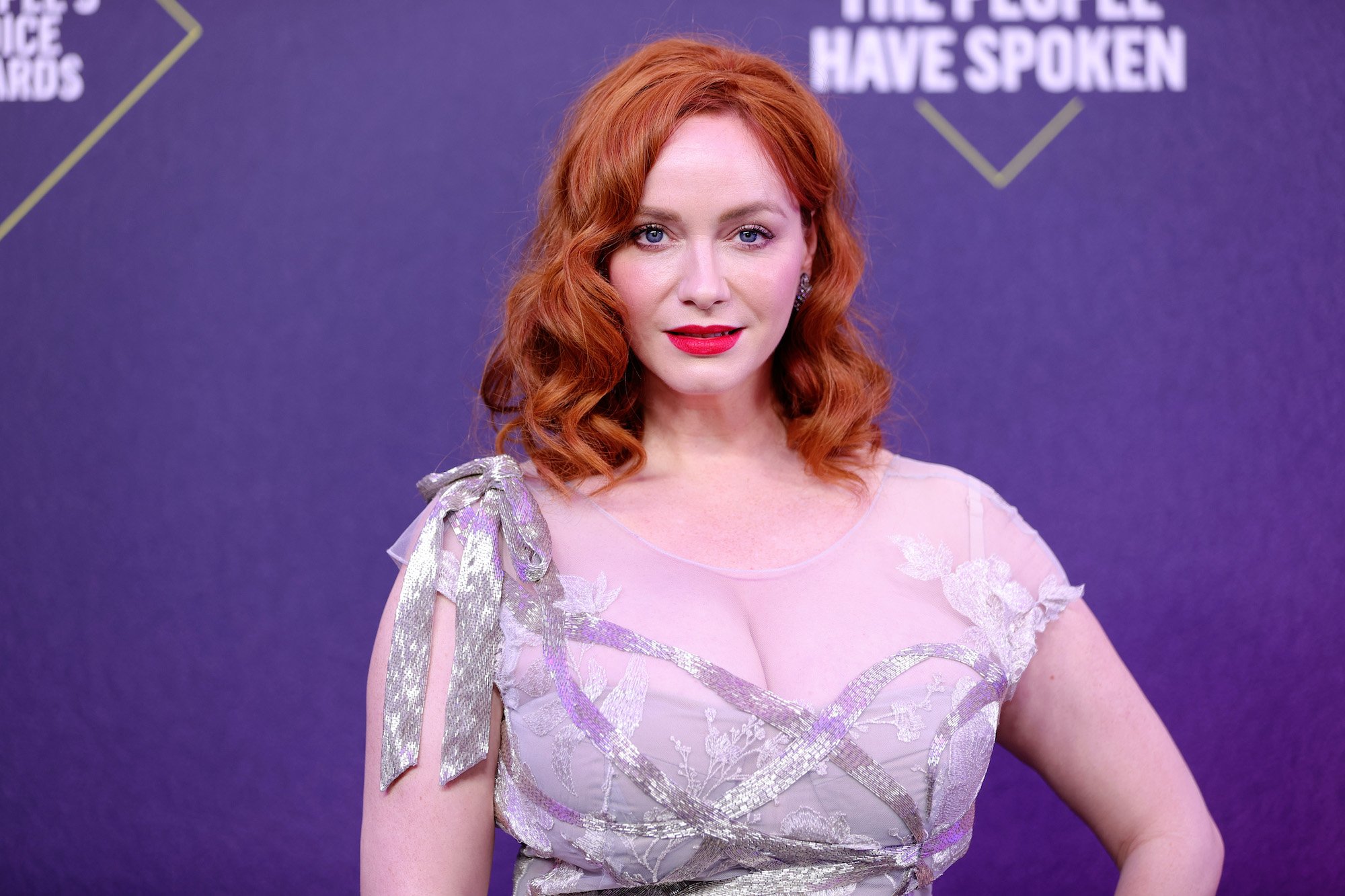 Christina Hendricks in front of a purple background