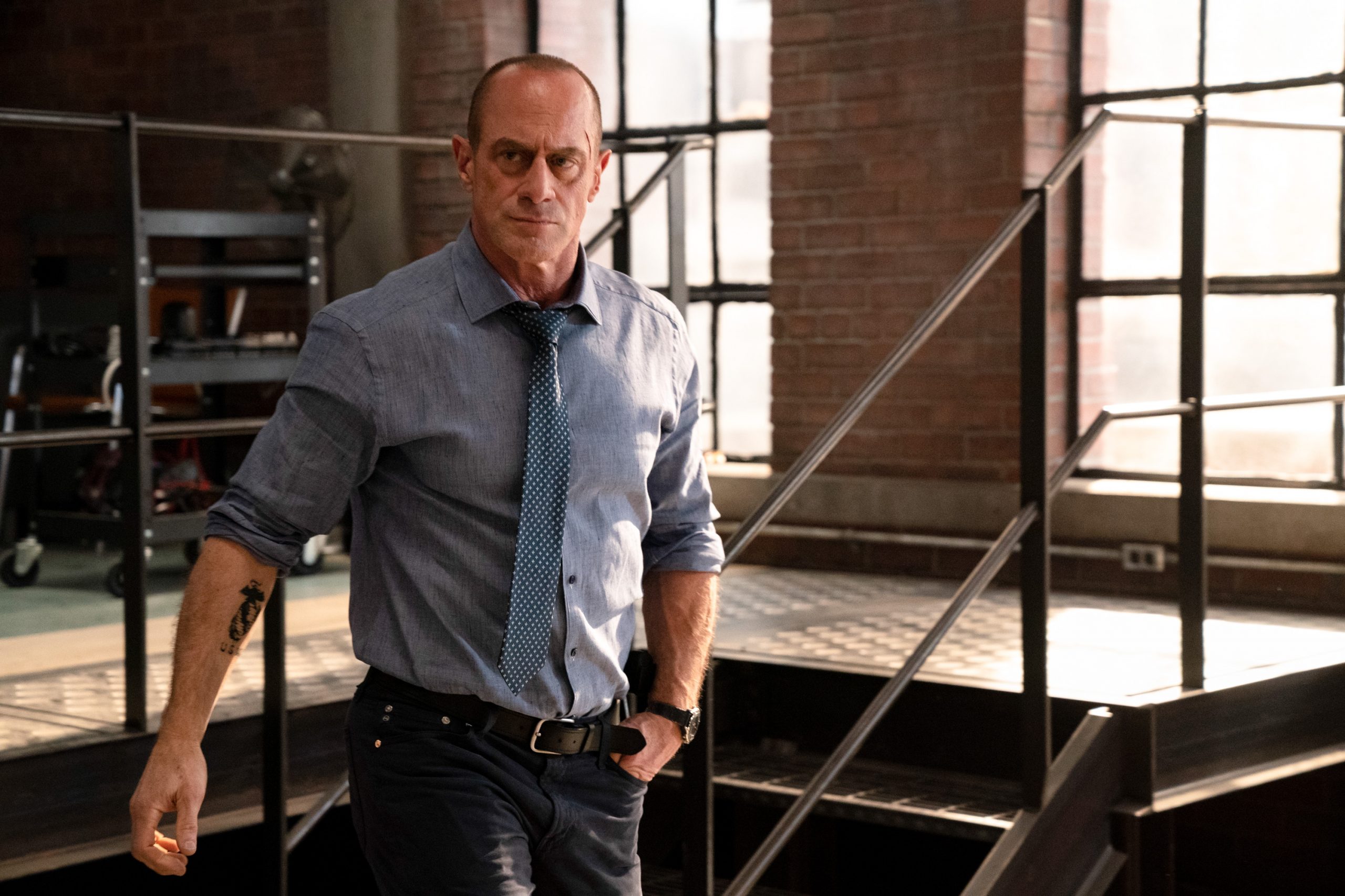 Christopher Meloni is in a blue shirt andplays Detective Elliot Stabler