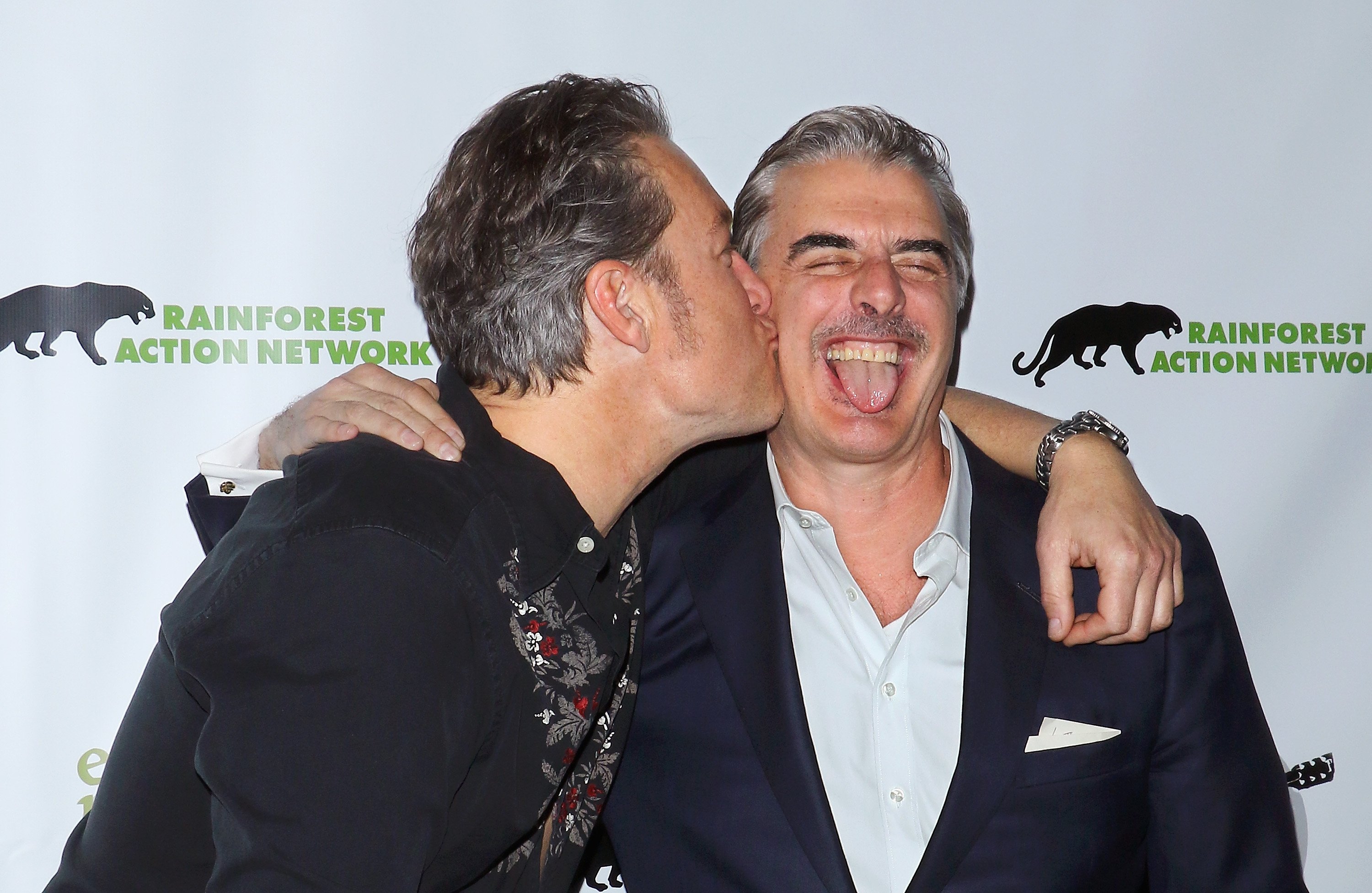 John Corbett kisses Chris Noth on the cheek at 2016 Eco Rock in New York City