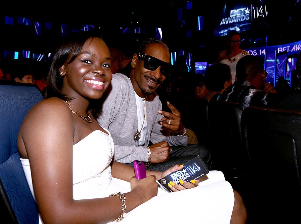 Snoop Dogg flashed the 'peace' sign while sitting next to his daughter Cori Broadus in a white, strapless dress, at the BET AWARDS '14