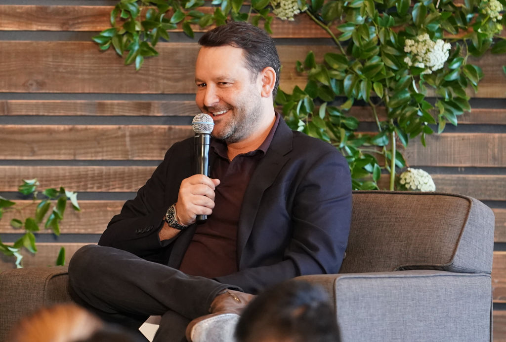 Dan Fogelman sits in a chair while smiling as he talks about his show, 'This Is Us' during a 20th Century Fox TV panel.