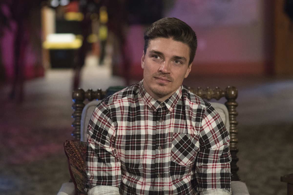 Dean Unglert sits in a chair on 'The Bachelor Winter Games'