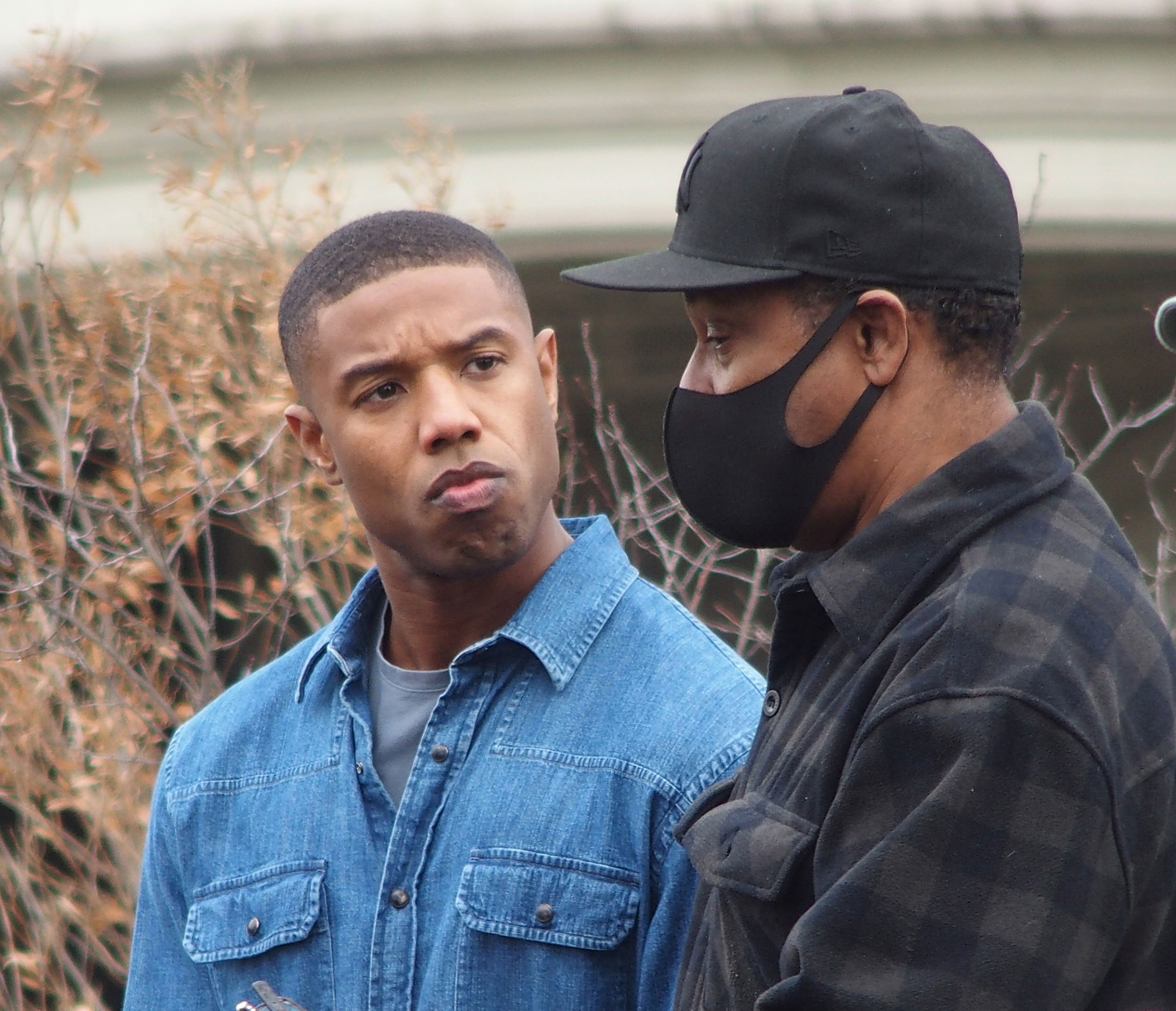 Denzel Washington wears a mask directing Michael B. Jordan