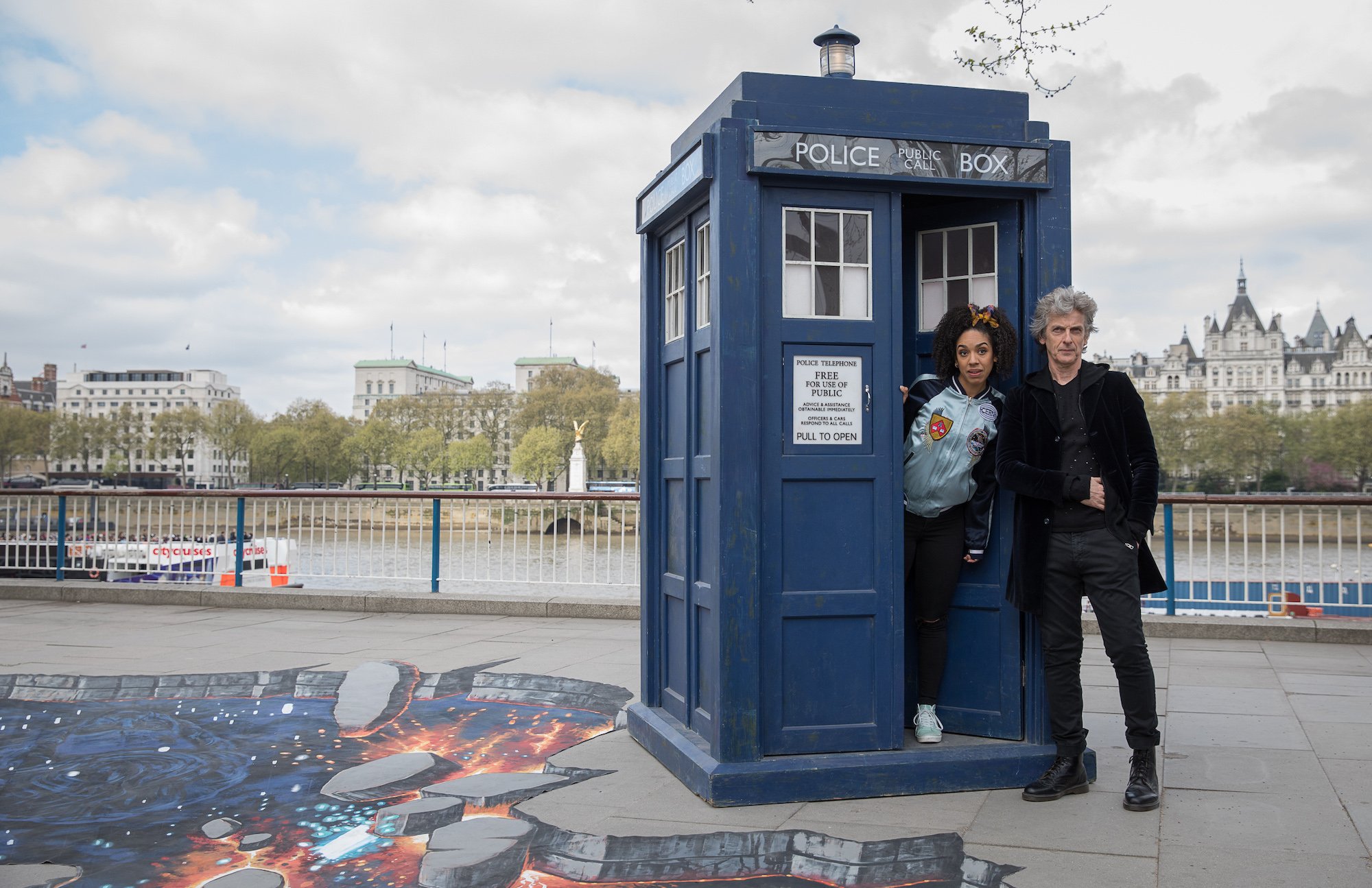 Peter Capaldi and Pearl Mackie posing in front of a TARDIS