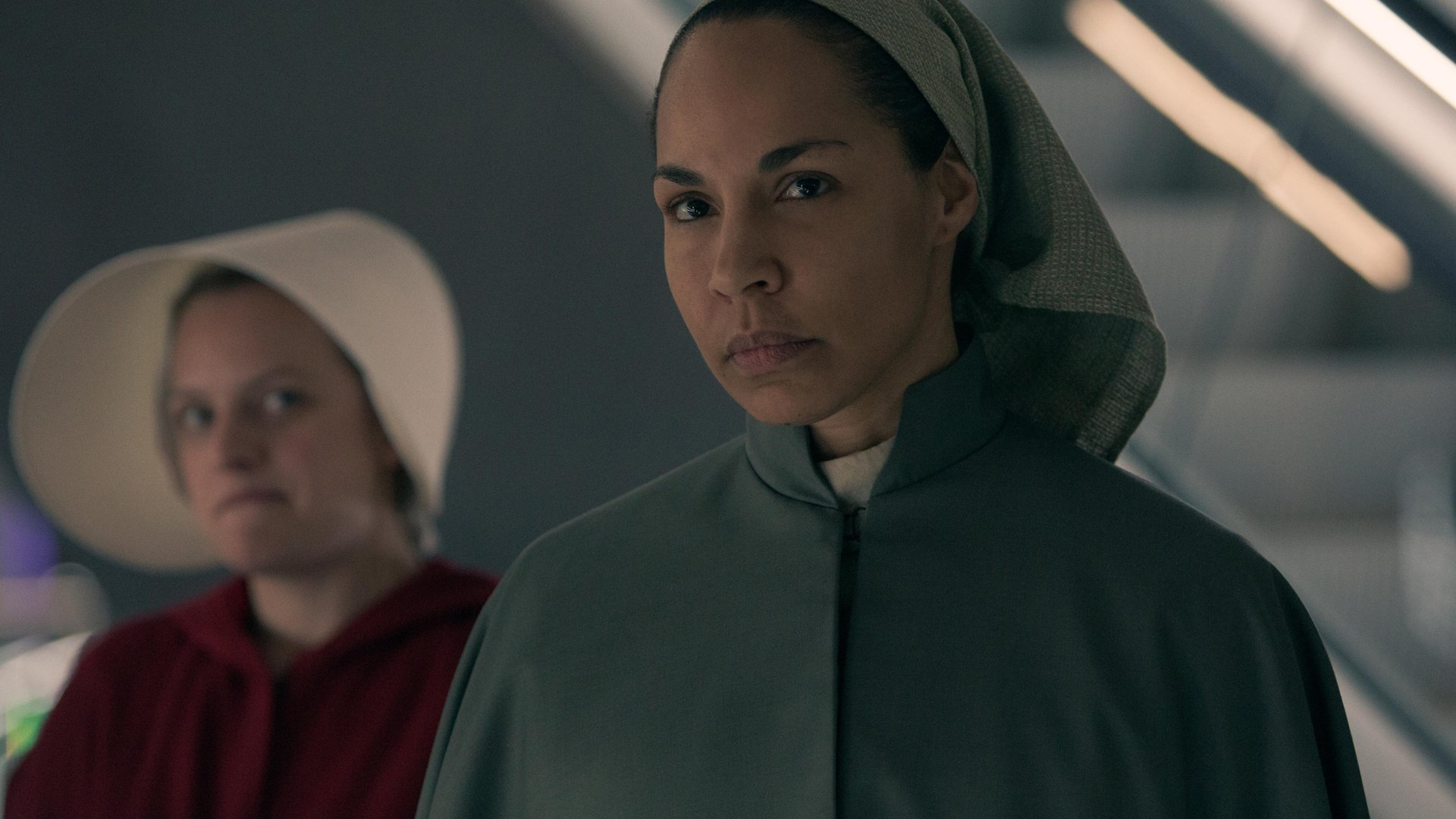 Elisabeth Moss as June stands behind Amanda Brugel as Rita in ‘The Handmaid’s Tale’ Season 3 Episode 6