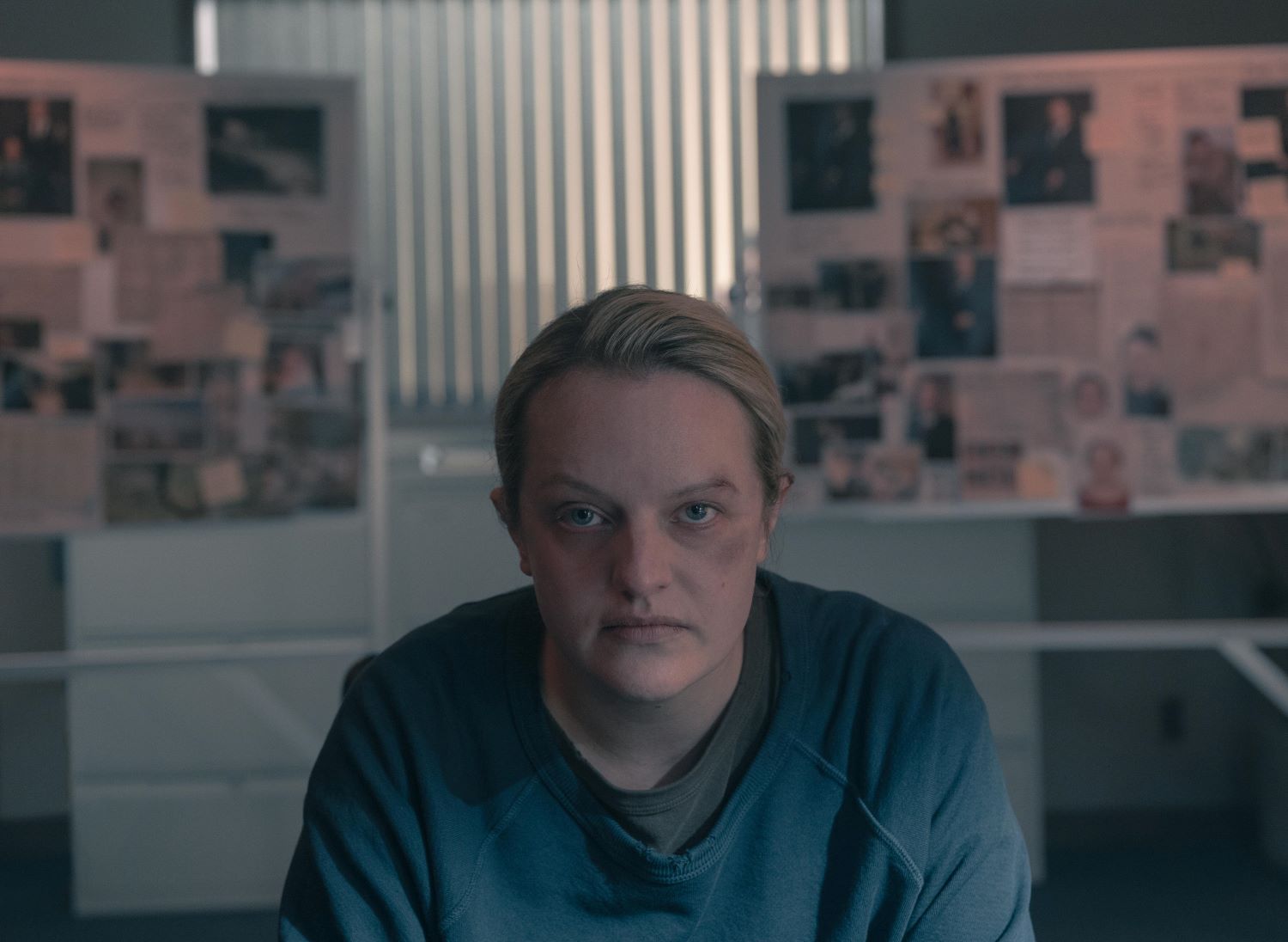 June Osborne wears a blue shirt and stares directly into the camera in 'The Handmaid's Tale'