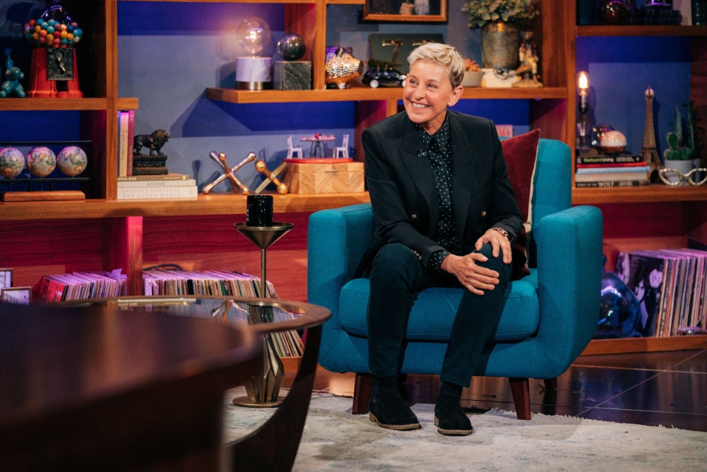 Ellen DeGeneres appears on 'The Late Late Show with James Corden' wearing a black suit as she sits in a chair, smiling. 