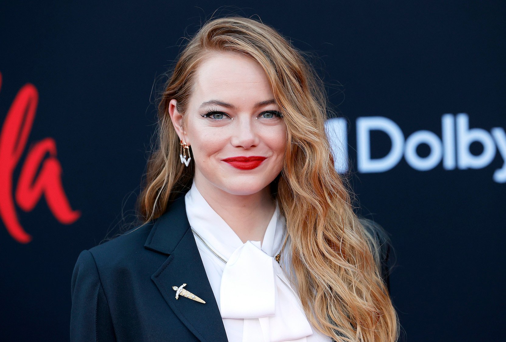 Emma Stone, who plays Cruella de Vil in 2021's 'Cruella' after Glenn Close's Cruella de Vil in '101 Dalmatians,' smiling at the premiere of the film