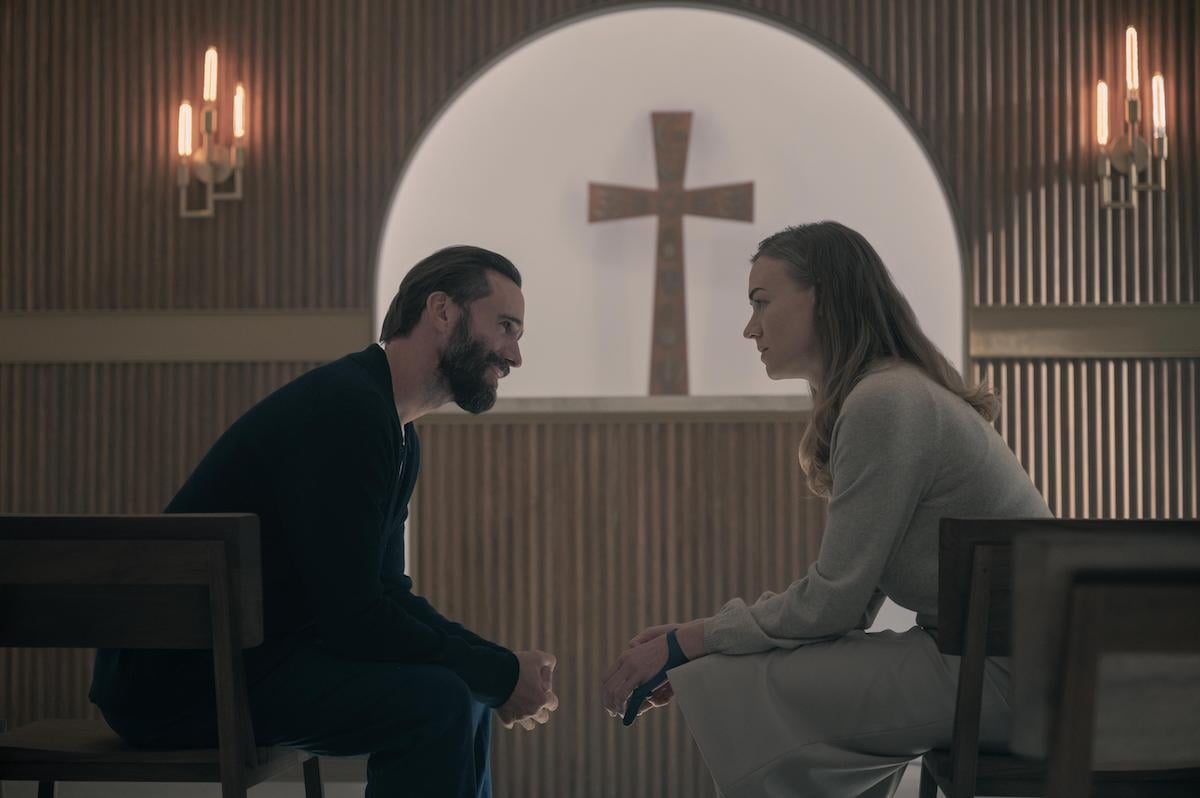 Joseph Fiennes (L) as Fred Waterford and Yvonne Strahovski (R) as Serena Joy Waterford sitting in a small chapel in 'The Handmaid's Tale' Season 4