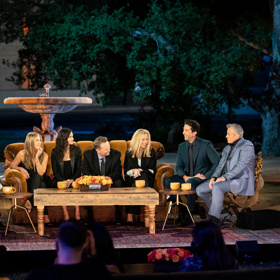 The cast of 'Friends' sits on the iconic orange couch for the reunion special