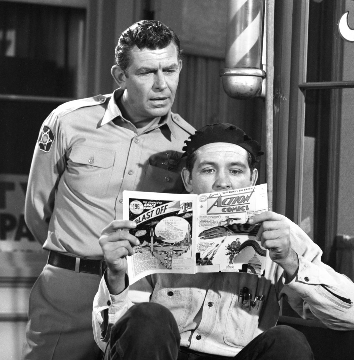 Andy Griffith looks over Goober Pyle actor George Lindsey as he reads a comic book in a scene from 'The Andy Griffith Show,' 1965