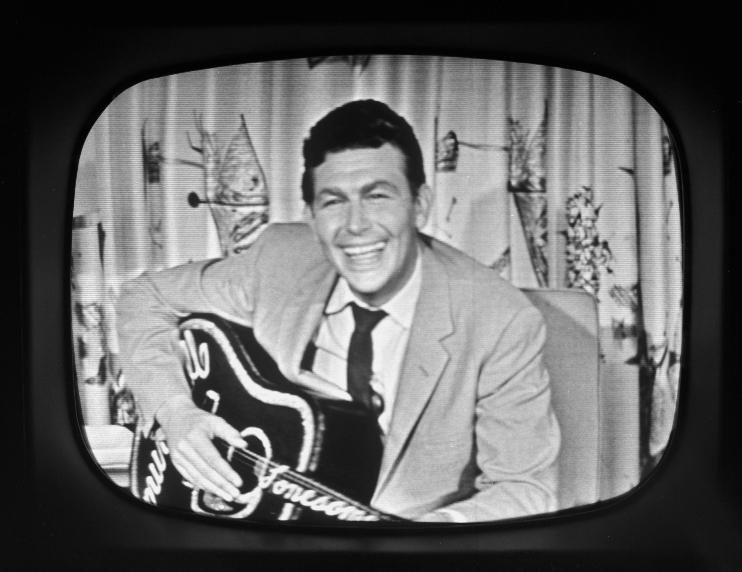 Actor Andy Griffith appears on television in 1957, playing a guitar and singing.