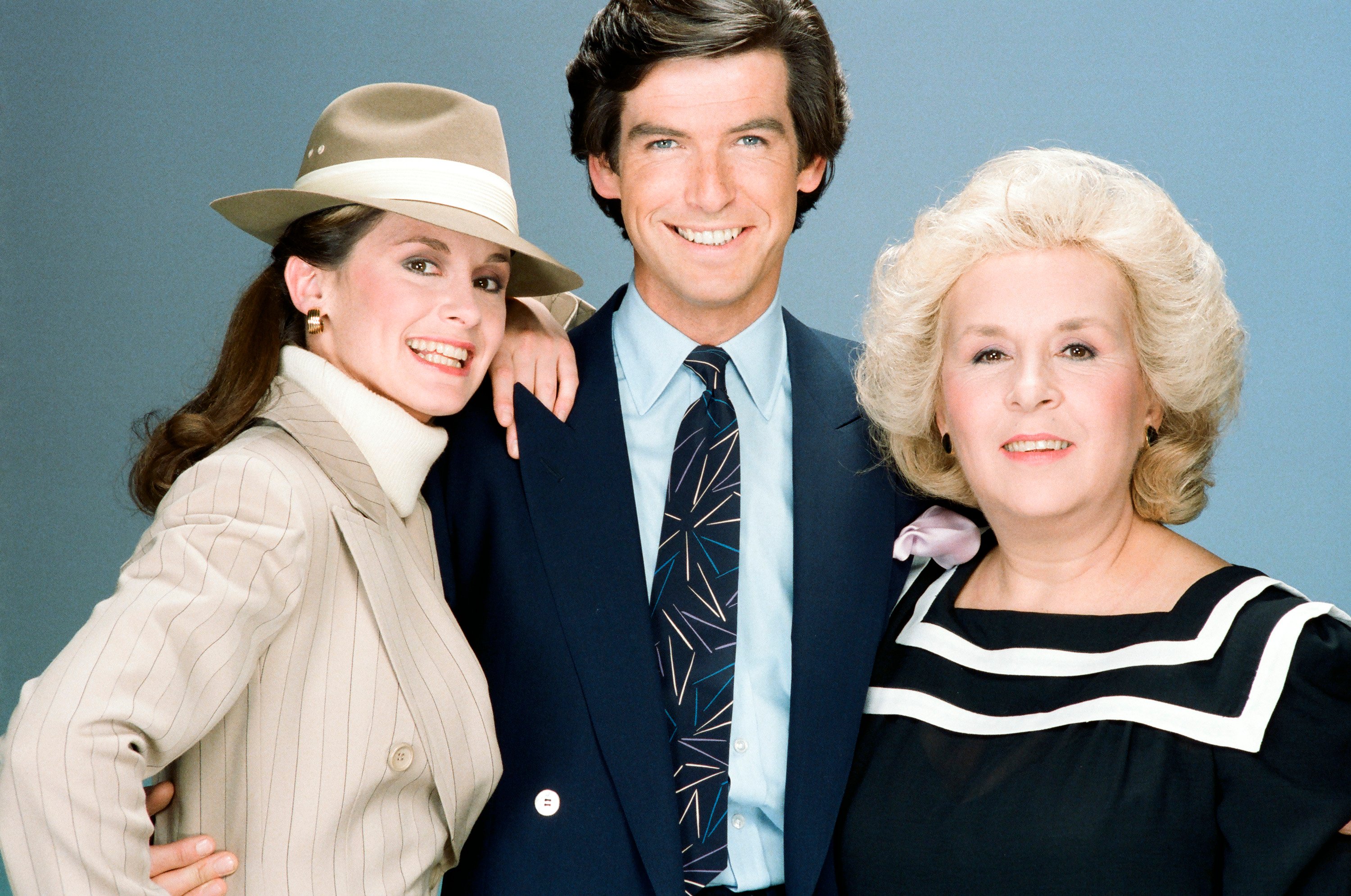 'Remington Steele' cast photo: (l-r) Stephanie Zimbalist as Laura Holt, Pierce Brosnan as Remington Steele, and Doris Roberts as Mildred Krebs