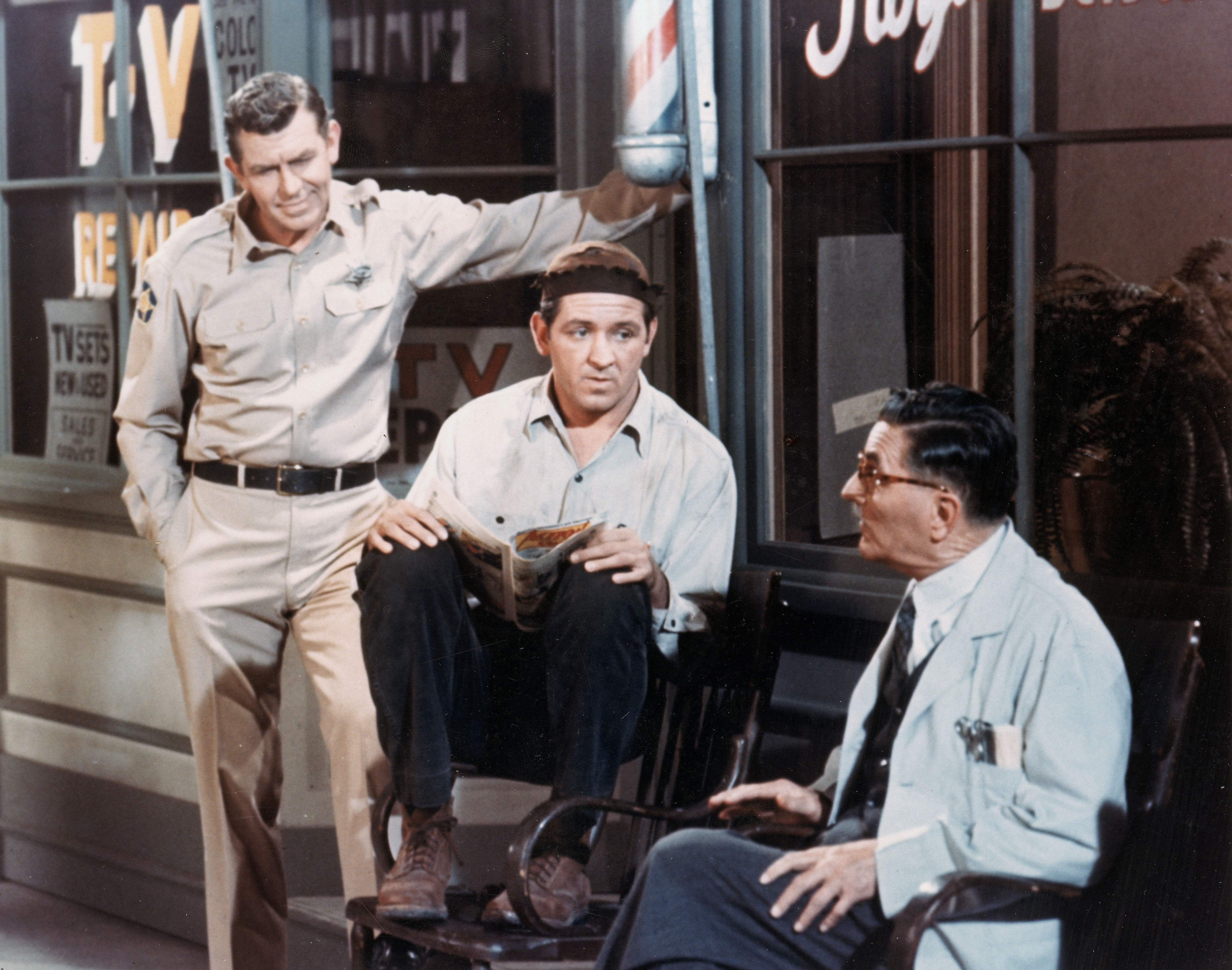 American actors Andy Griffith, George Lindsey, and Howard McNear sit outside Floyd's barber shop in a still from the television series, 'The Andy Griffith Show,' circa 1966.