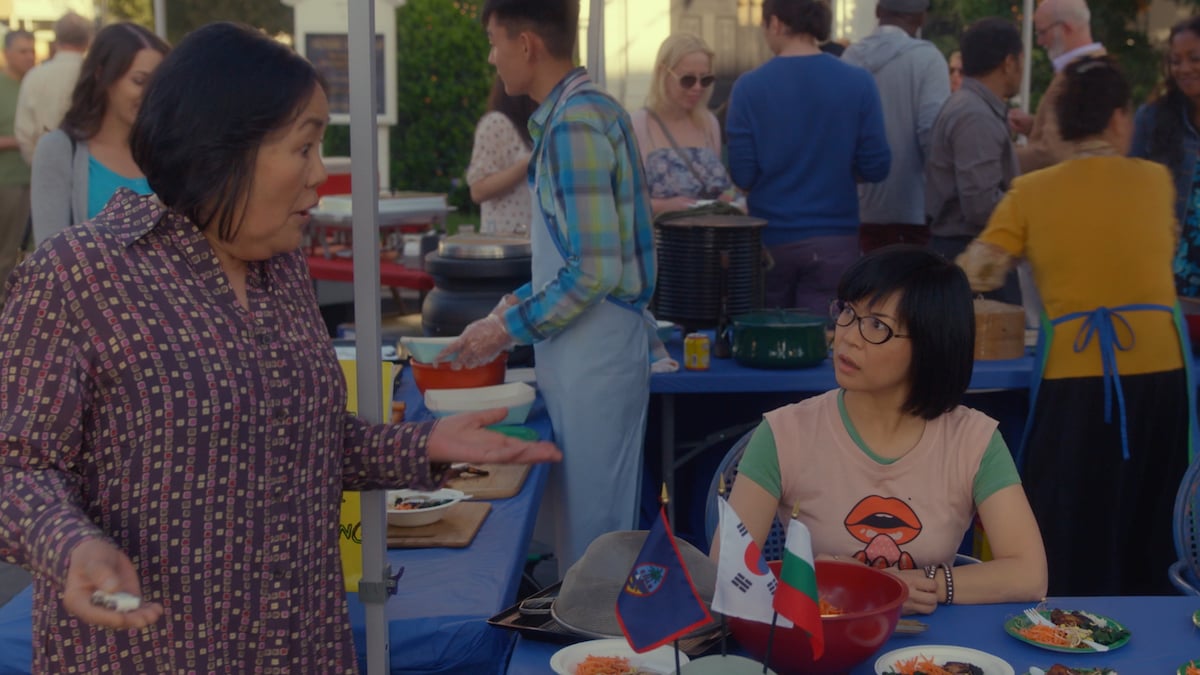 Emily Kuroda as Mrs. Kim and Keiko Agena as Lane Kim talk to each other at a festival in 'Gilmore Girls: A Year in the Life'