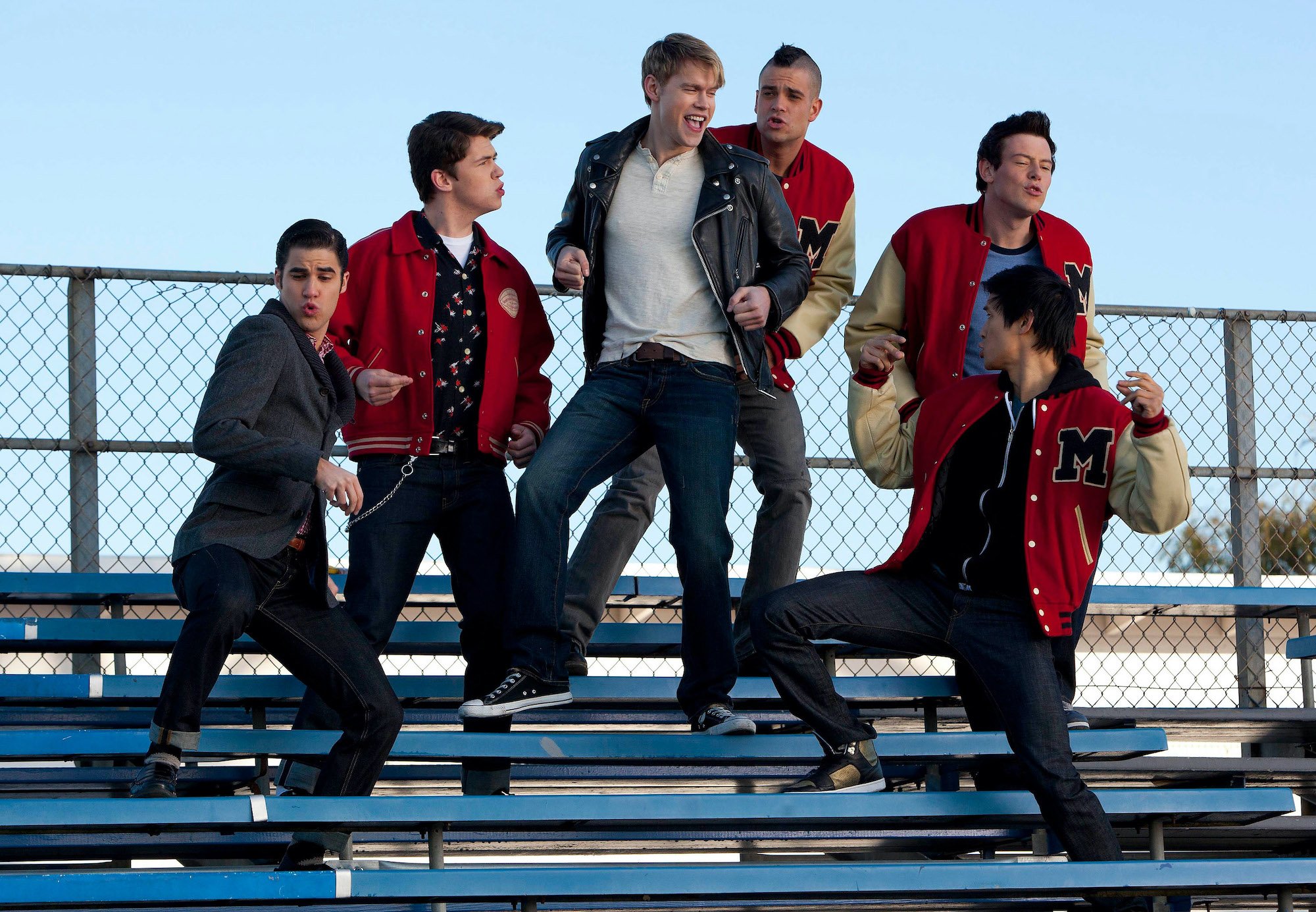 'Glee' principal male cast, singing on a set of bleachers