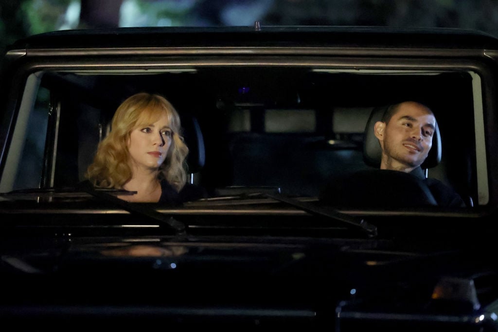 Christina Hendricks as Beth Boland and Manny Montana as Rio sit in a car at night in the most uncomfortable of ways.