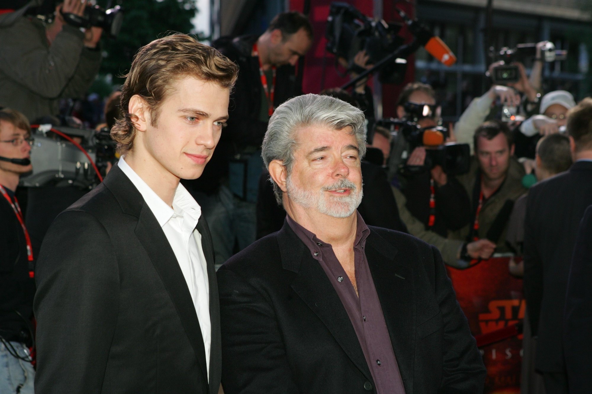 (L-R) Hayden Christensen and George Lucas in front of a crowd