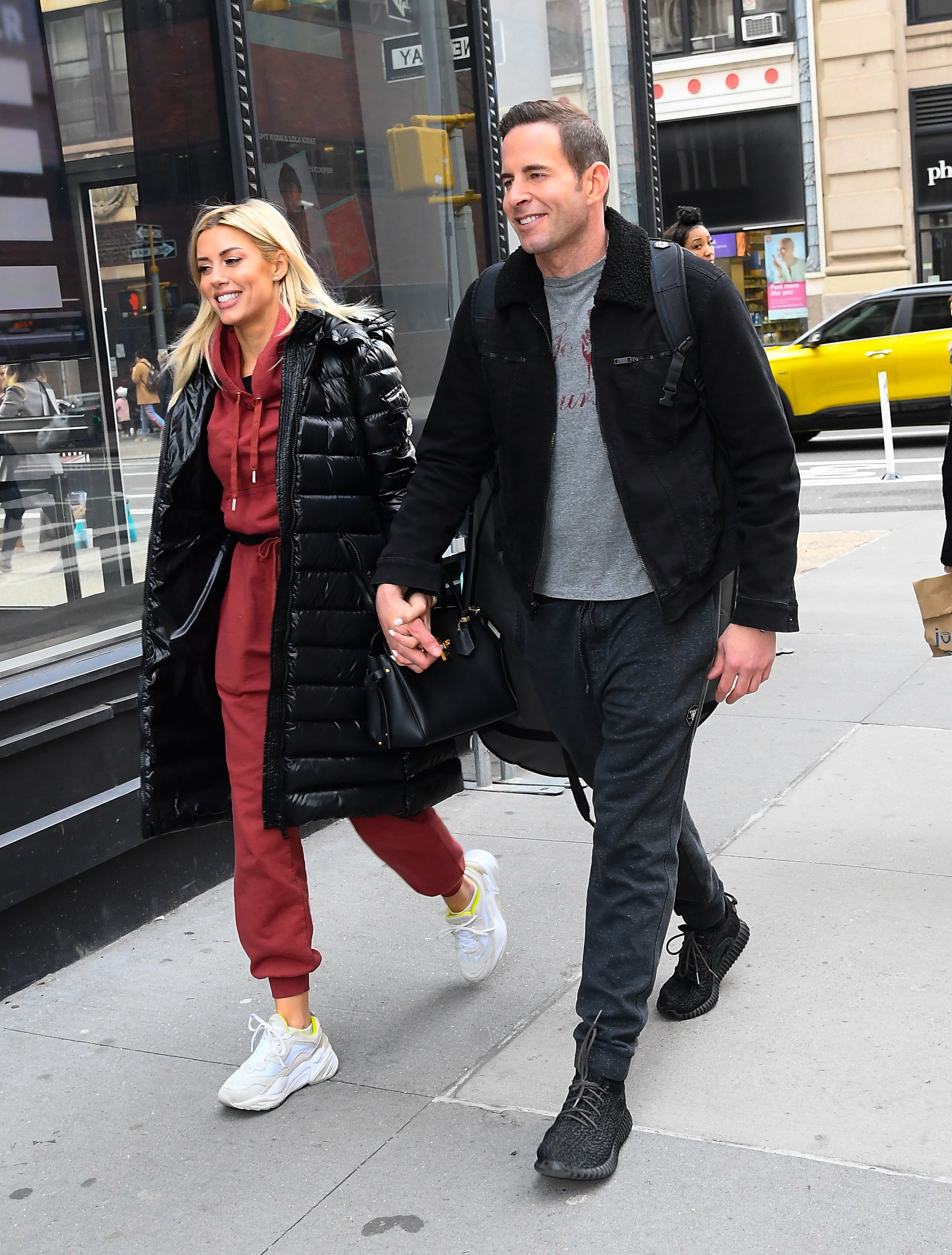 'Flip or Flop' star Tarek EL Moussa and Heather Rae Young smile and hold hands walking together