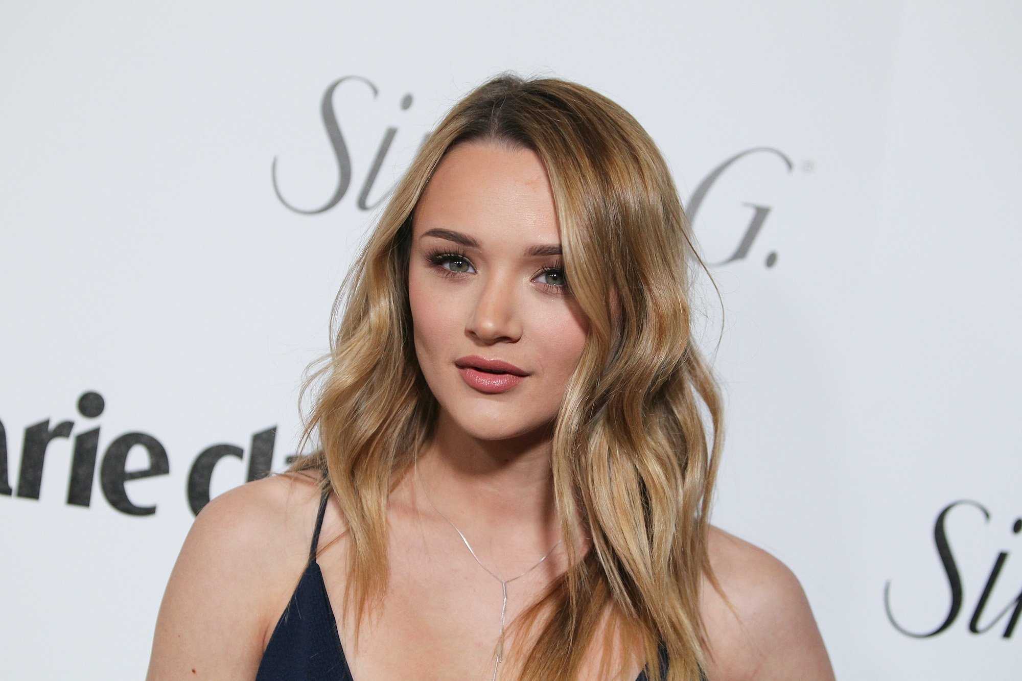Hunter King smiling in front of a white backdrop