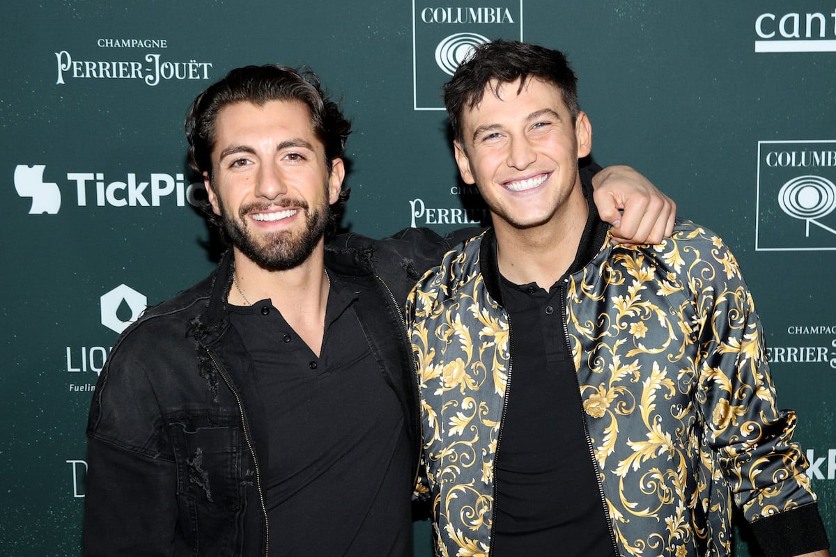 Blake Horstmann and Jason Tartick pose together smiling on a red carpet.