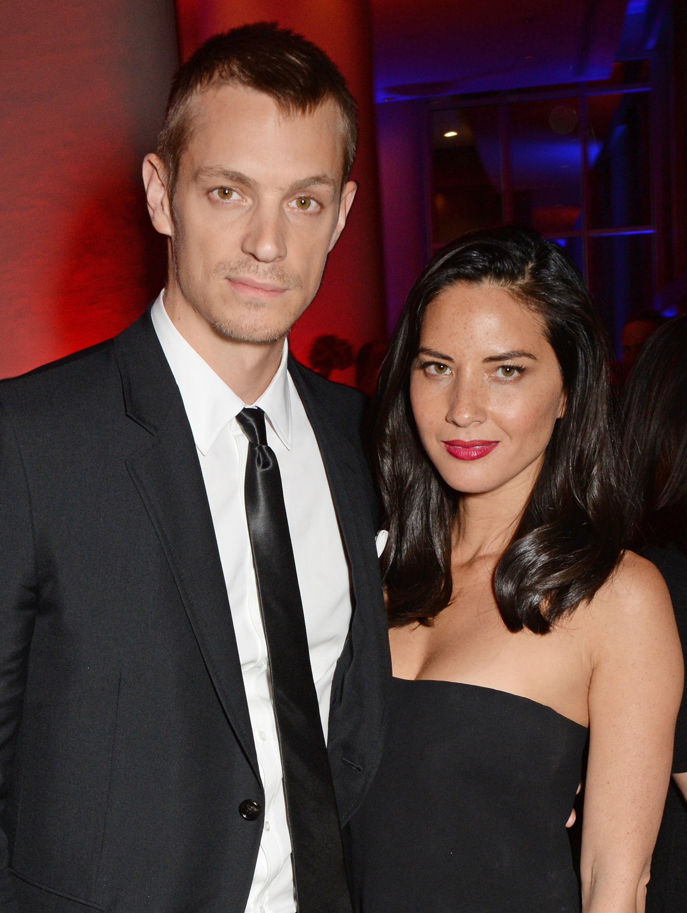 Joel Kinnaman and Olivia Munn pose for a picture at the after party of the world premiere of RoboCop in 2014