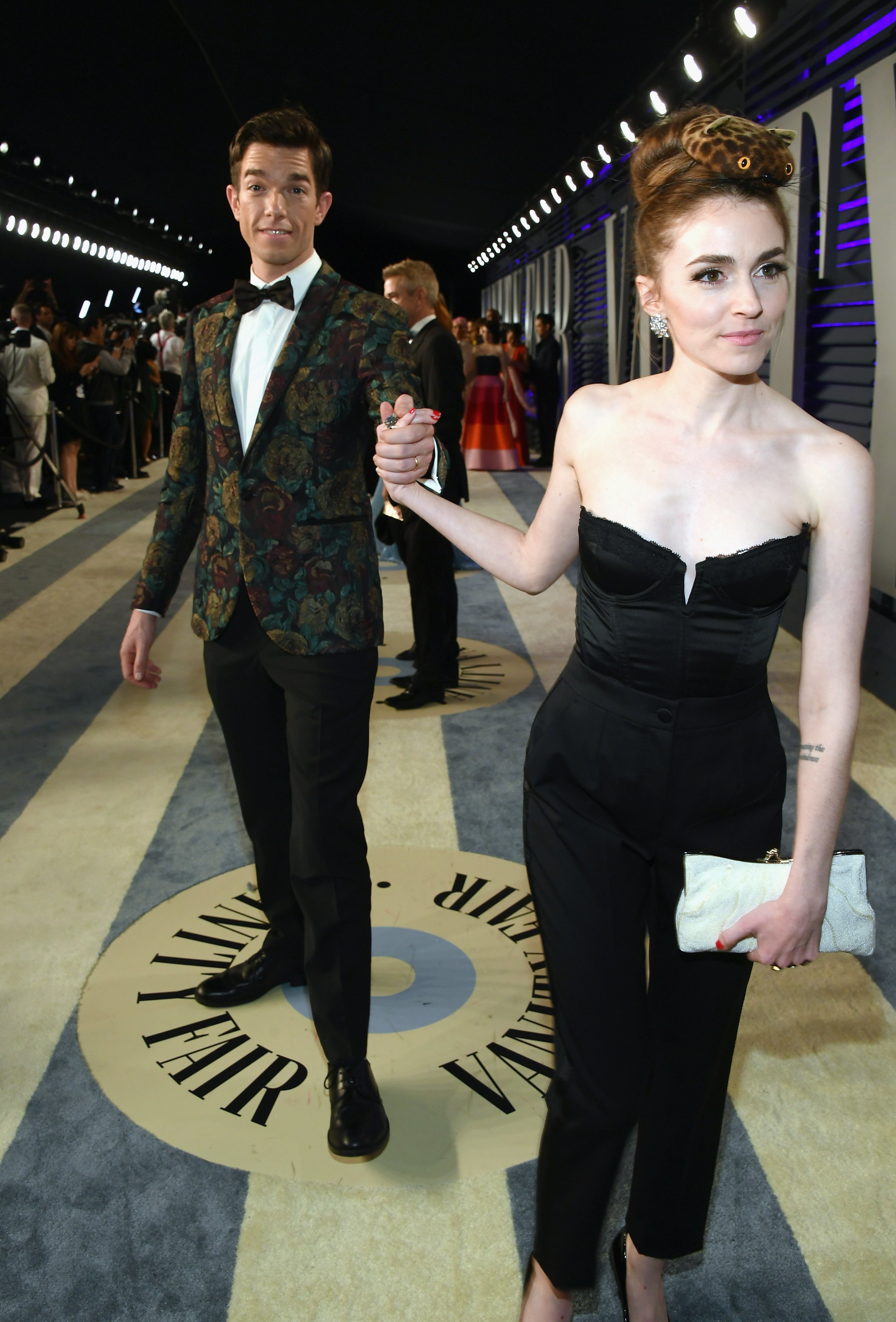 John Mulaney is lead by his wife, Annamarie Tendler, into the 2019 Vanity Fiar Oscar Party hosted by Radhika Jones