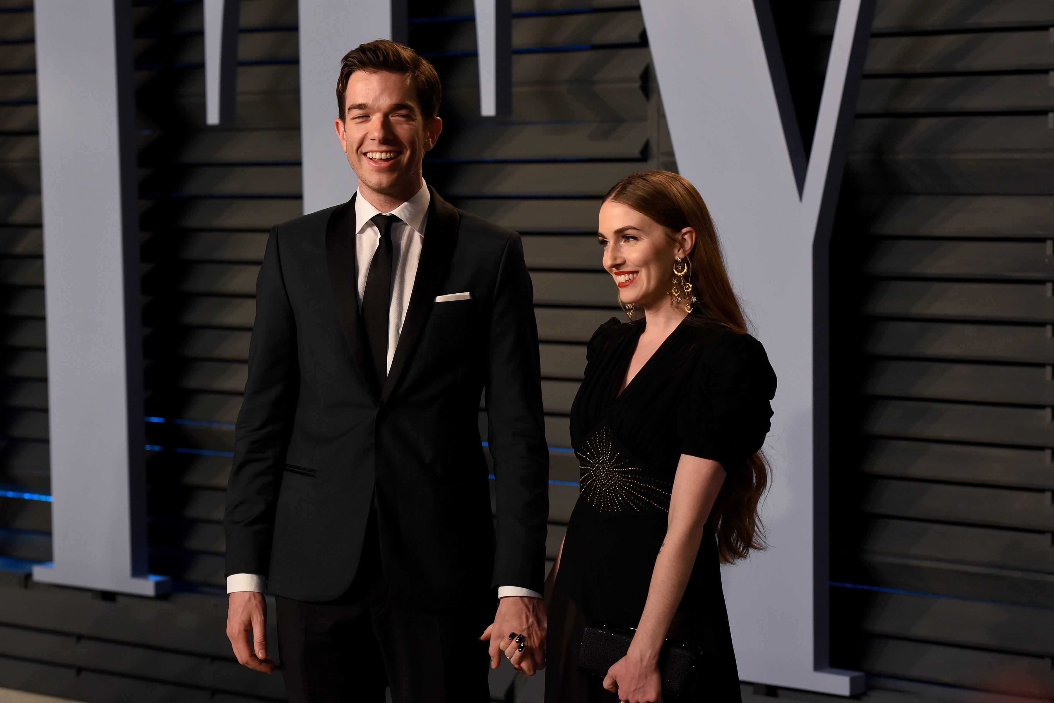 John Mulaney and Annamarie Tendler pose for photos before heading incie to the 2018 Vanity Fiar Oscar Party