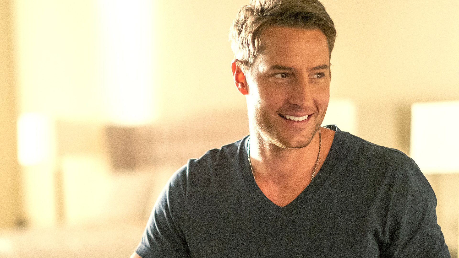 Justin Hartley as Kevin smiles at someone in ‘This Is Us’ Season 5 Episode 16