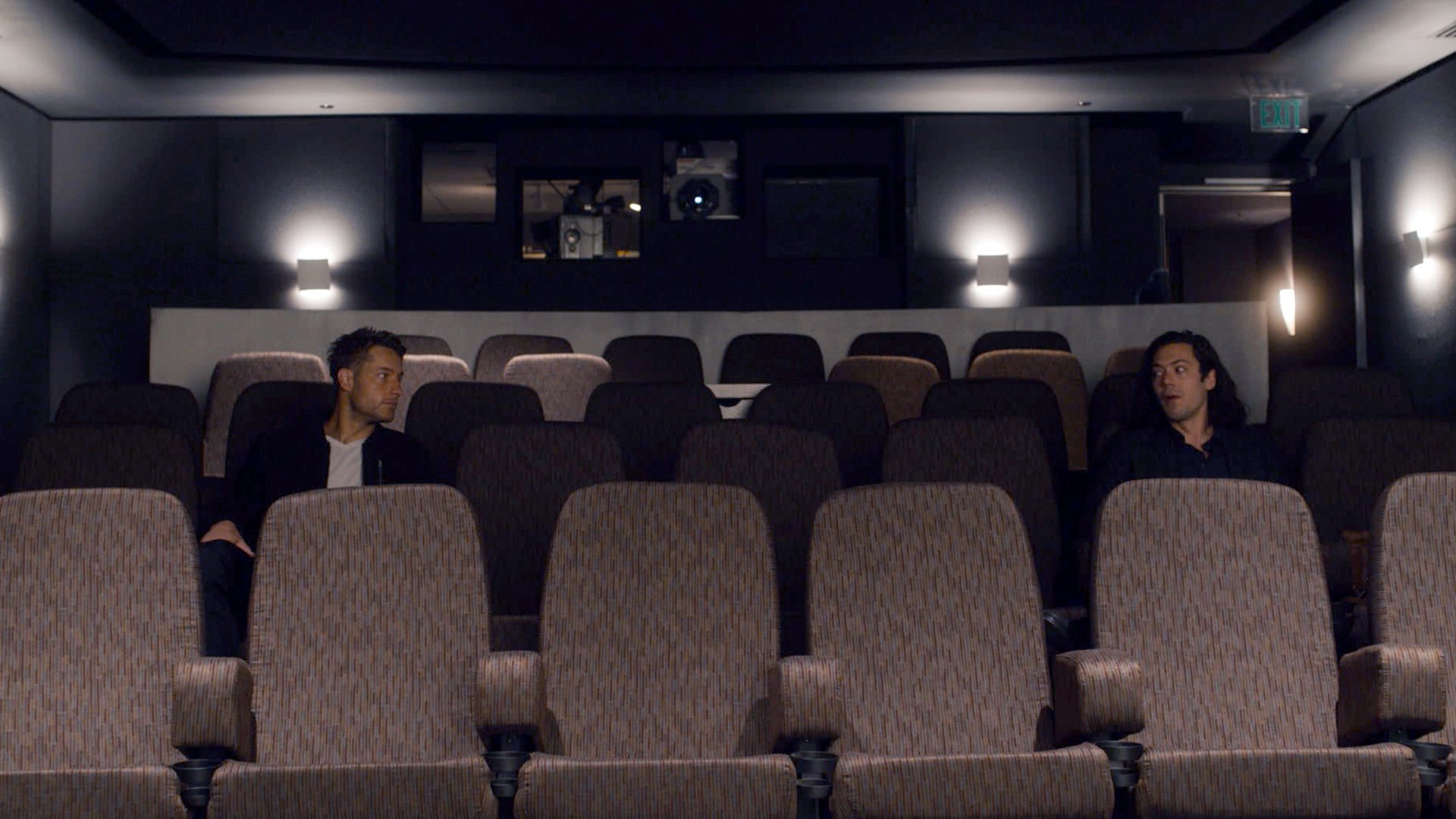 Justin Hartley as Kevin and Stephen Friedrich as Jordan Martin Foster sit in a theater together in ‘This Is Us Season 5 Episode 14