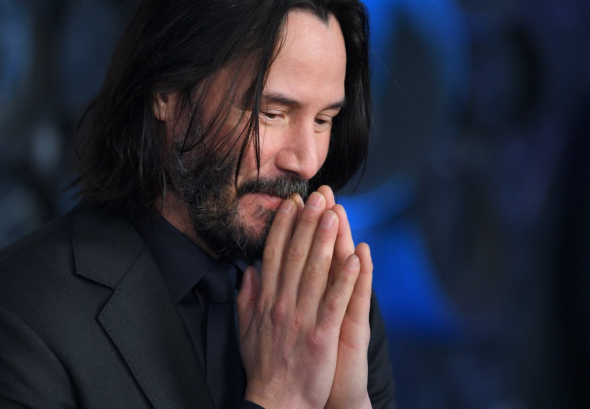 Keanu Reeves stands with his hands together at the 'John Wick: Chapter 3' special screening