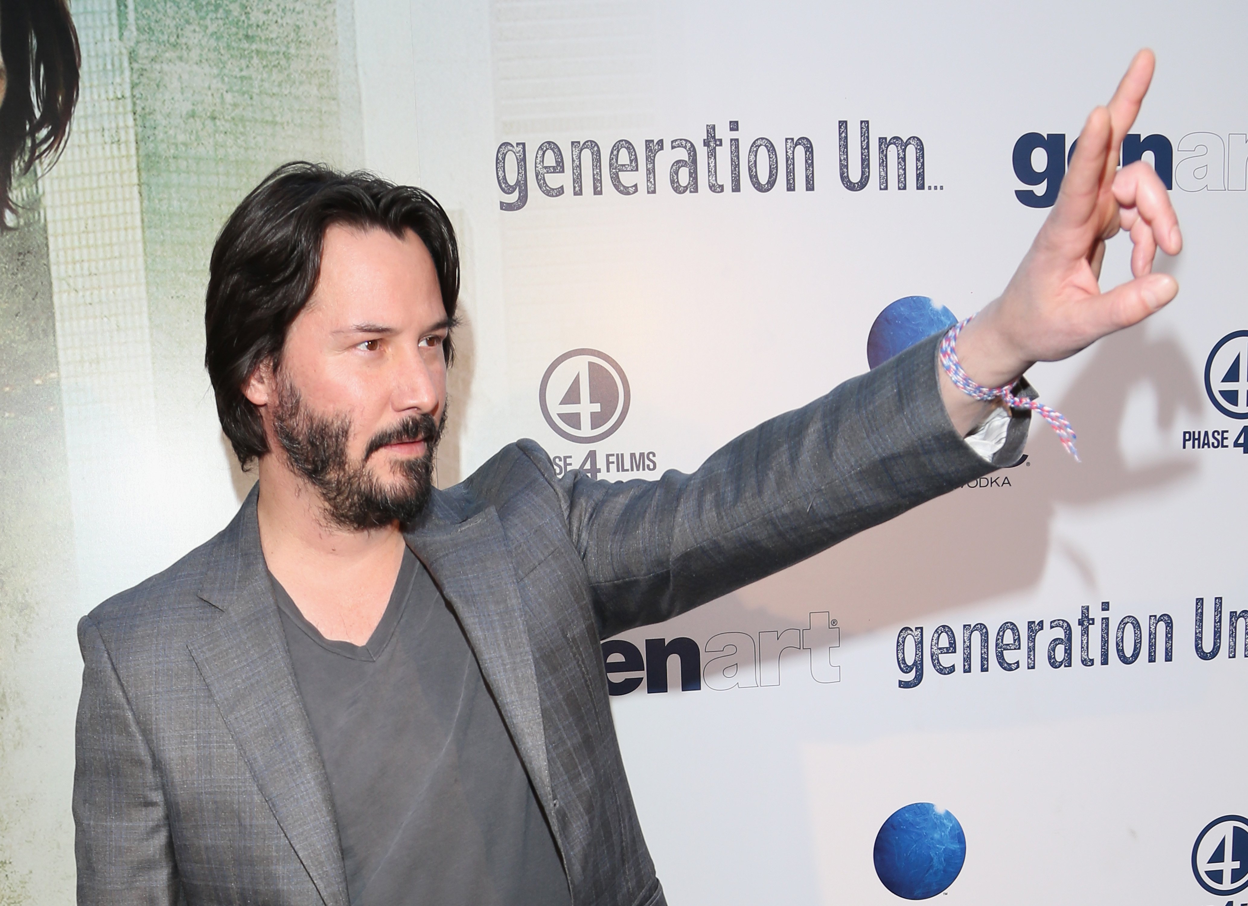 Keanu Reeves waves at the Generation Um... premiere